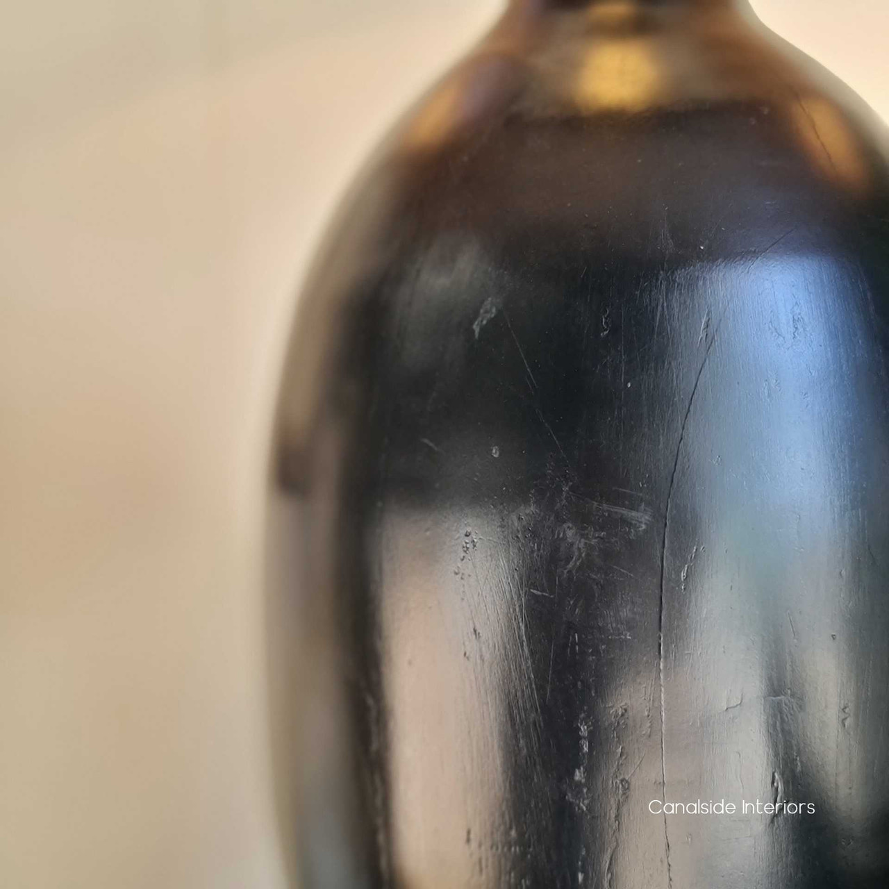 The Clemence Lamp features a beautiful black ceramic base and a crisp white linen shade.