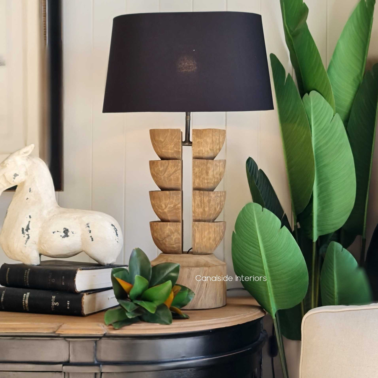 The rustic recycled charm of the Ambroise Lamp set in a modern living room, blending classical elegance with modern sensibilities.