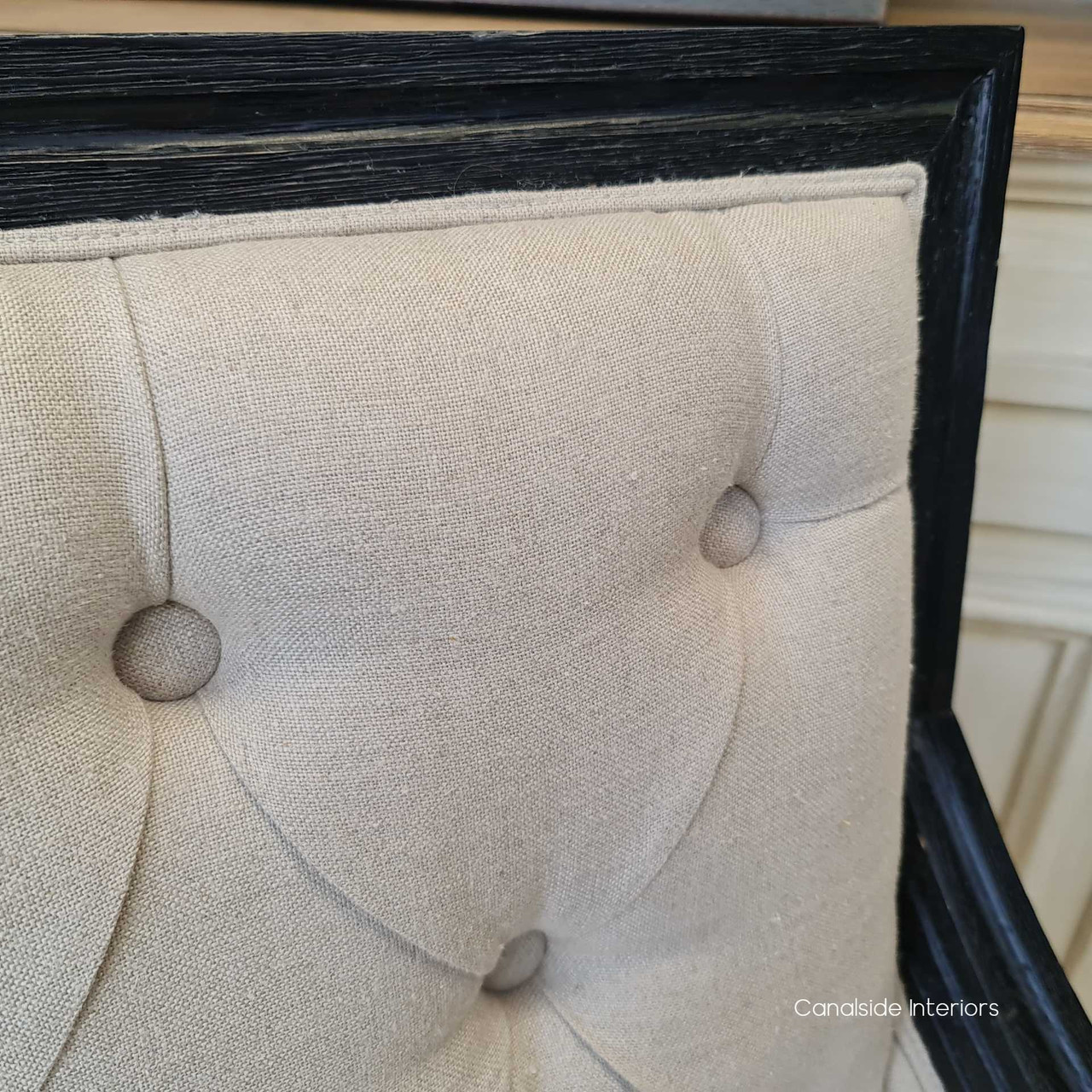 Close-up on the intricate button tufted detailing, showcasing the armchair's timeless elegance and quality craftsmanship.