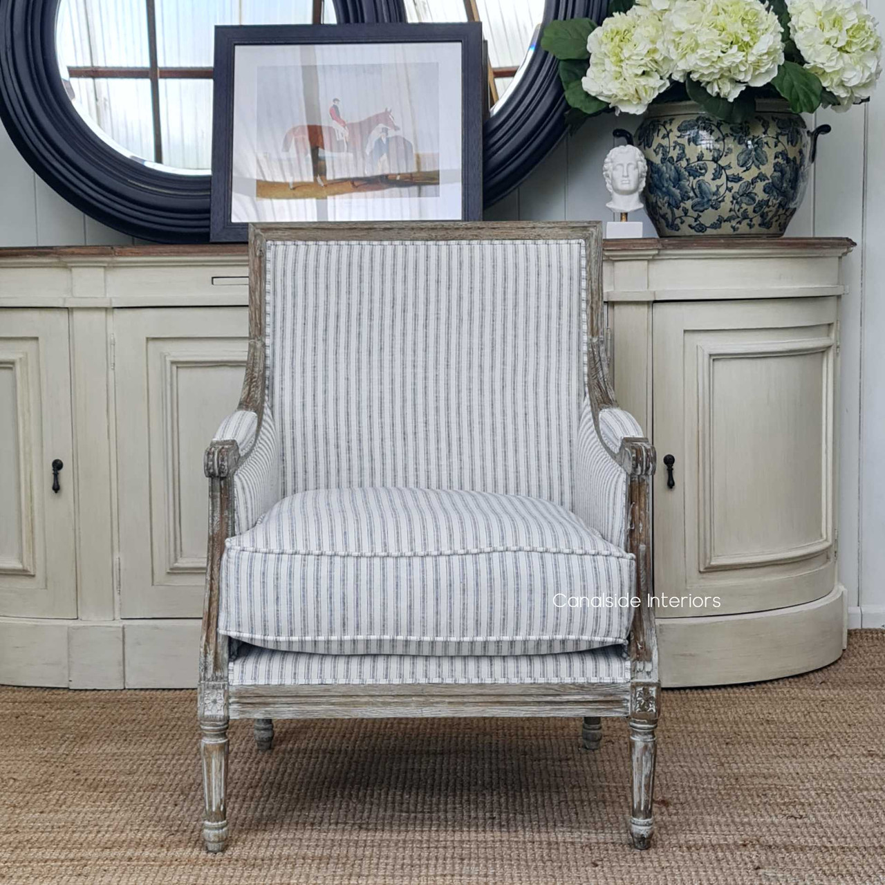 Front view of the Pearson Armchair with blue striped linen upholstery, a symbol of coastal elegance for the living room.