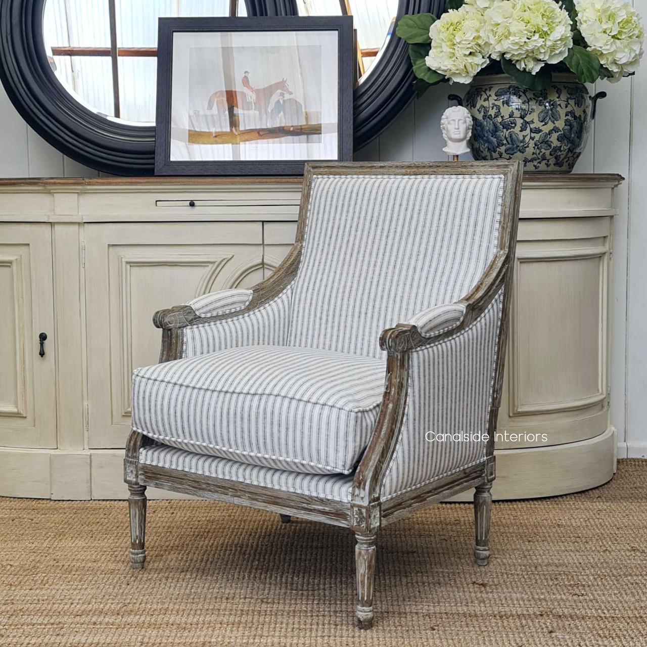In-situ view of the armchair in a coastal-themed lounge room, enhancing the space with its timeless design.