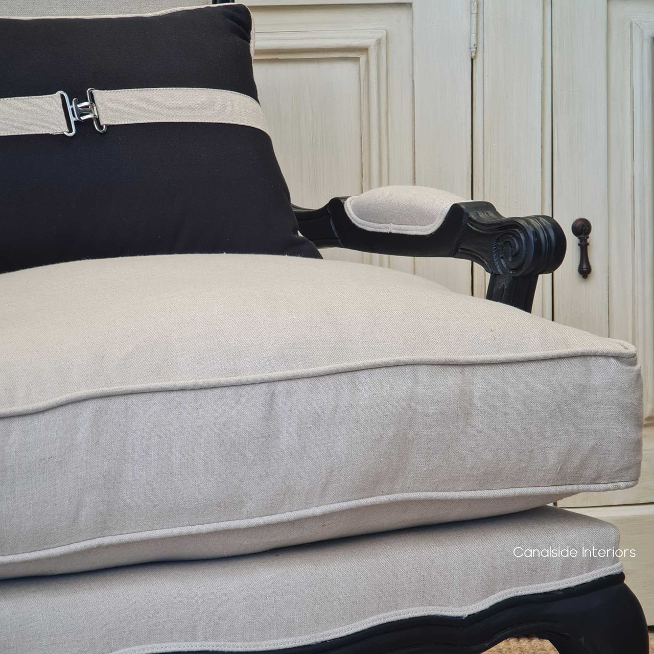 Detail shot highlighting the linen blend upholstery's texture and the armchair's intricate stitching.