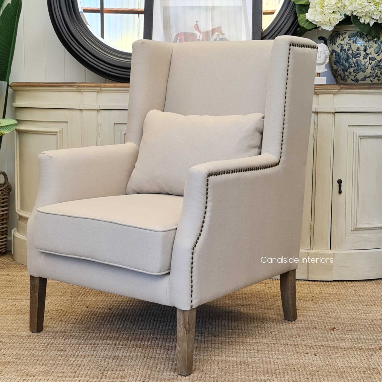 Angled perspective of the Bayview Armchair, emphasizing its gently sloped arms and the elegant interplay of textures and colours.