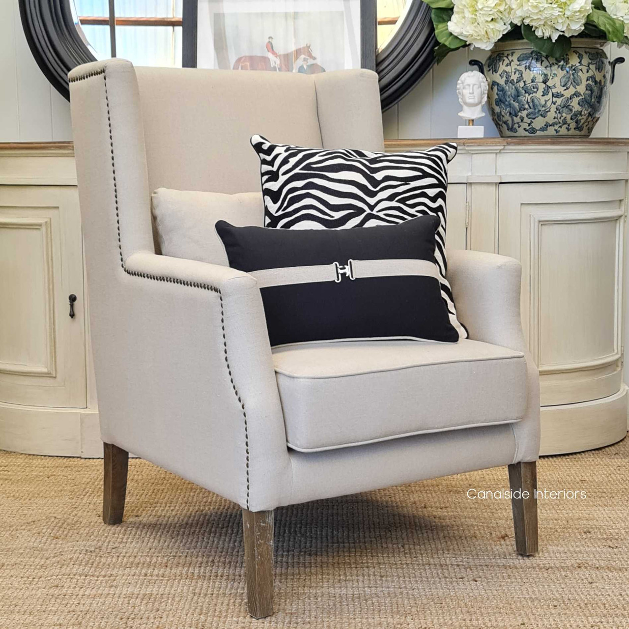 The armchair set in a Hamptons-style living room, illustrating its perfect fit within luxurious coastal-themed decors.