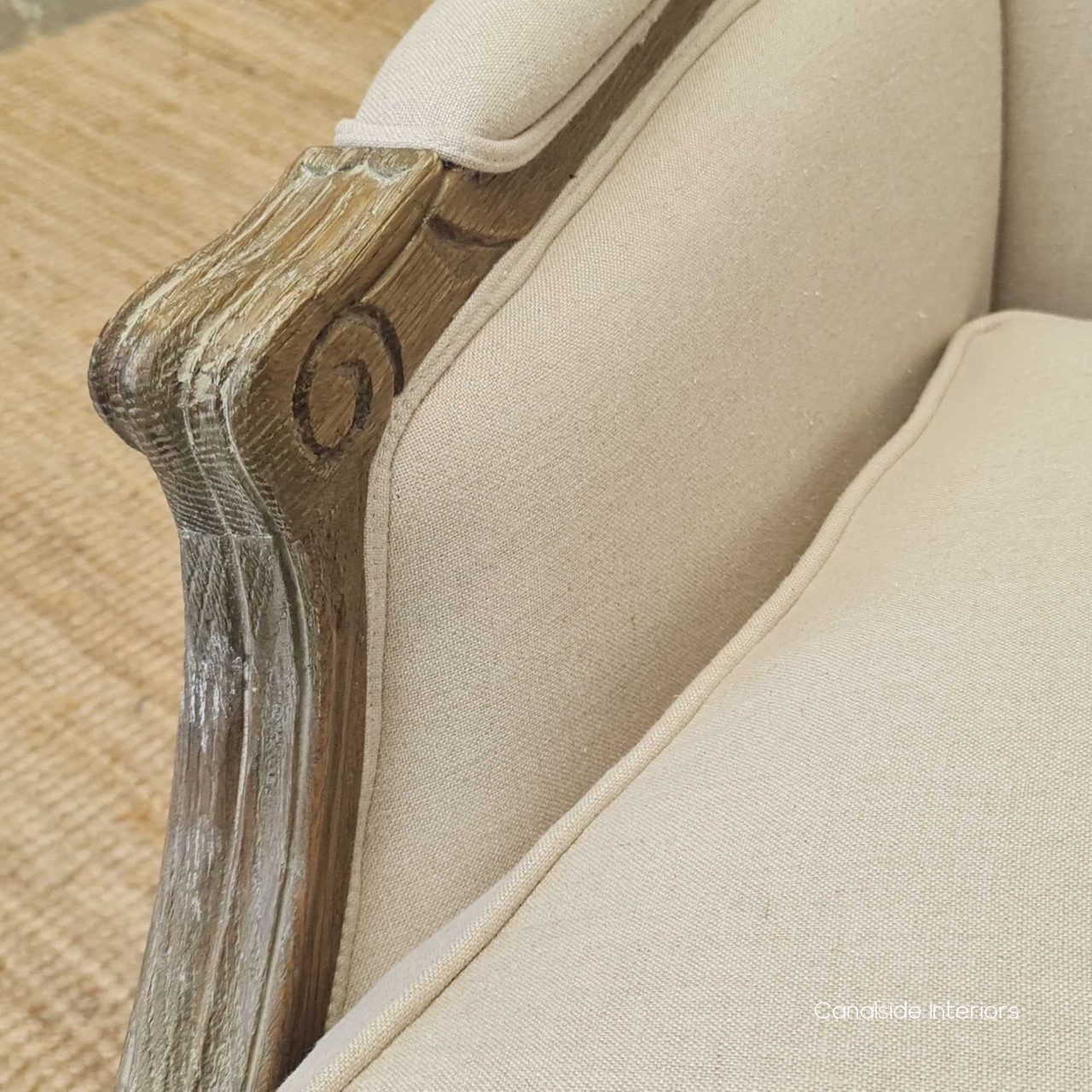 Detail shot of the chair's upholstery and hand-carved frame, showcasing the quality materials and attention to detail, suited for luxury living room or lounge room spaces.