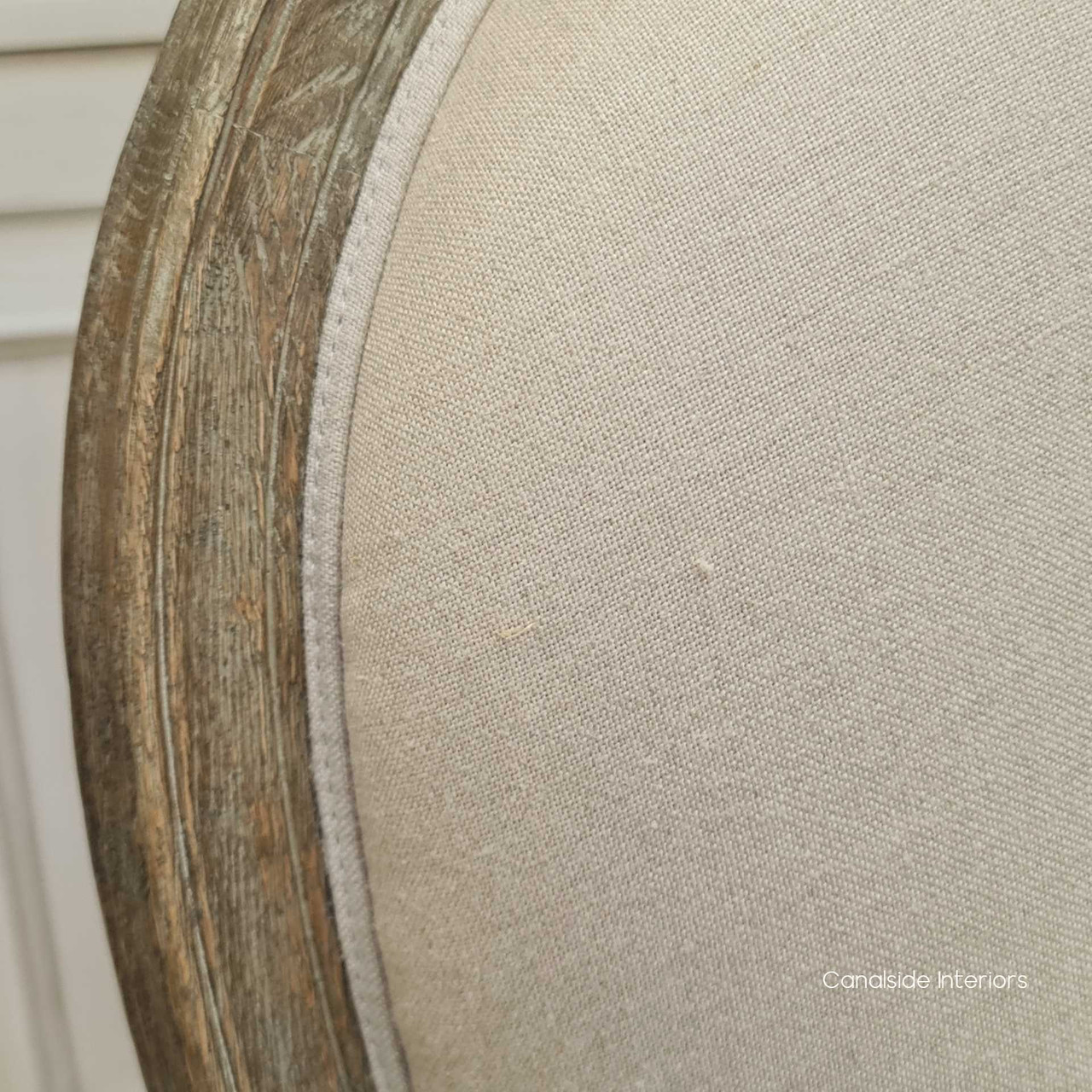 Close-up of the armchair's weathered oak frame, highlighting the craftsmanship and French Provincial design, ideal for adding classical elegance to any interior.