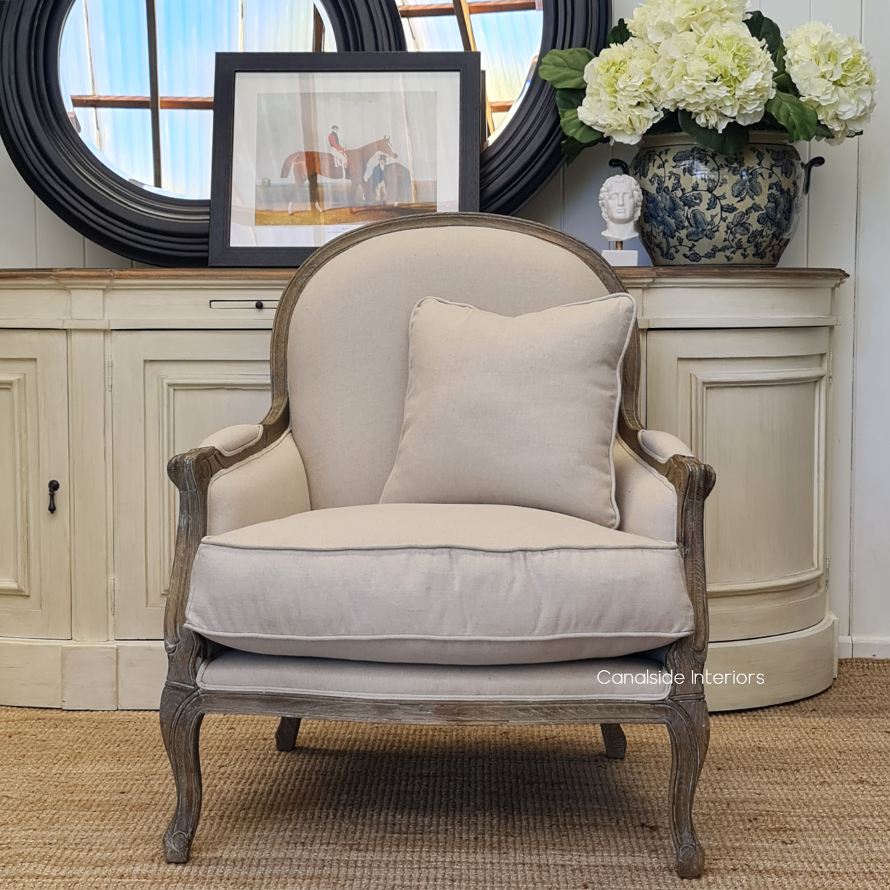 The armchair as part of a sophisticated library or home office setup, focusing on its ability to merge functionality with aesthetic appeal, featuring timeless and quality design.