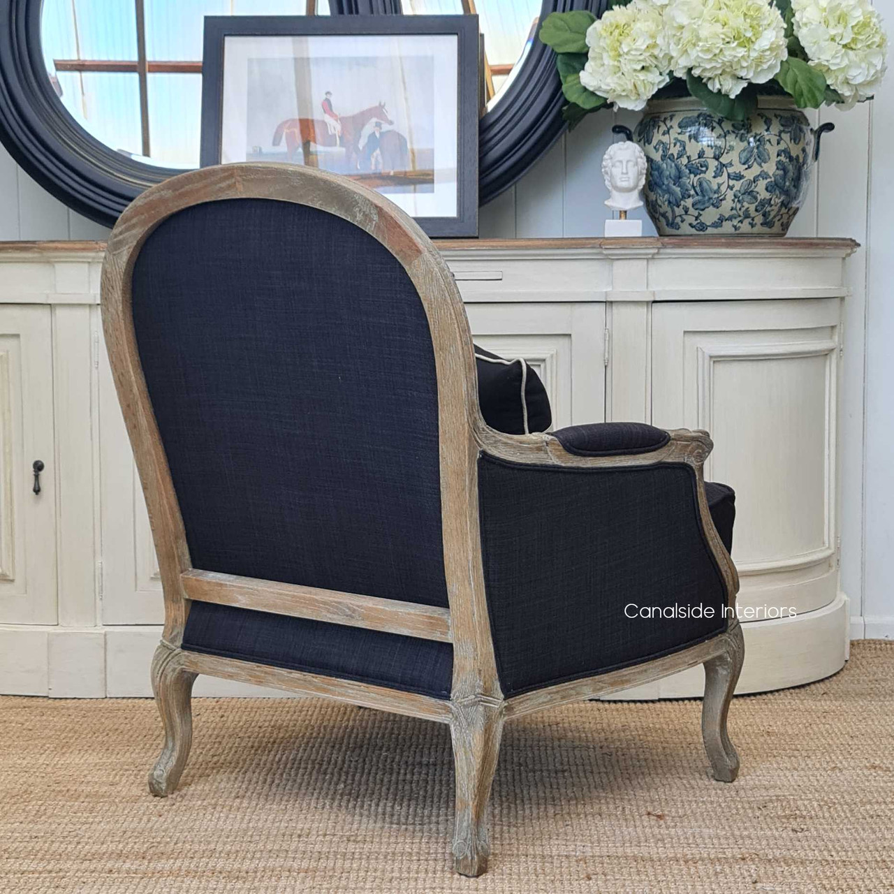 The Monette Armchair paired with a decorative buffet, highlighting the chair's functional elegance in a lounge room setting.