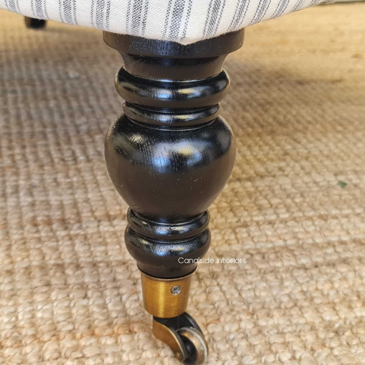 Black castors detail, accenting the Ascott Armchair's ability to blend into both classical and modern interiors.