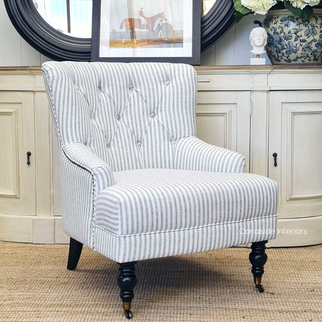 The Ascott armchair in a chic living room setting, serving as both a functional seating option and a sophisticated decorative piece.