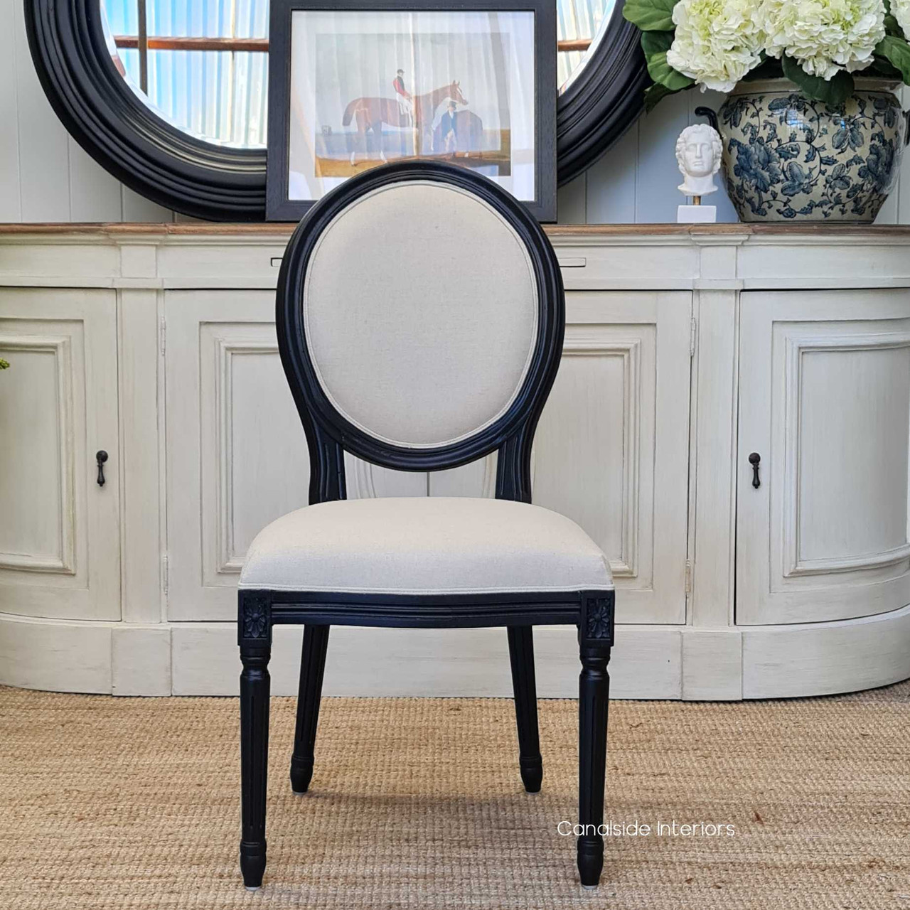 Sansa's classic oval back design chair in black, bringing a touch of timeless sophistication to a modern coastal living room - Canalside Interiors