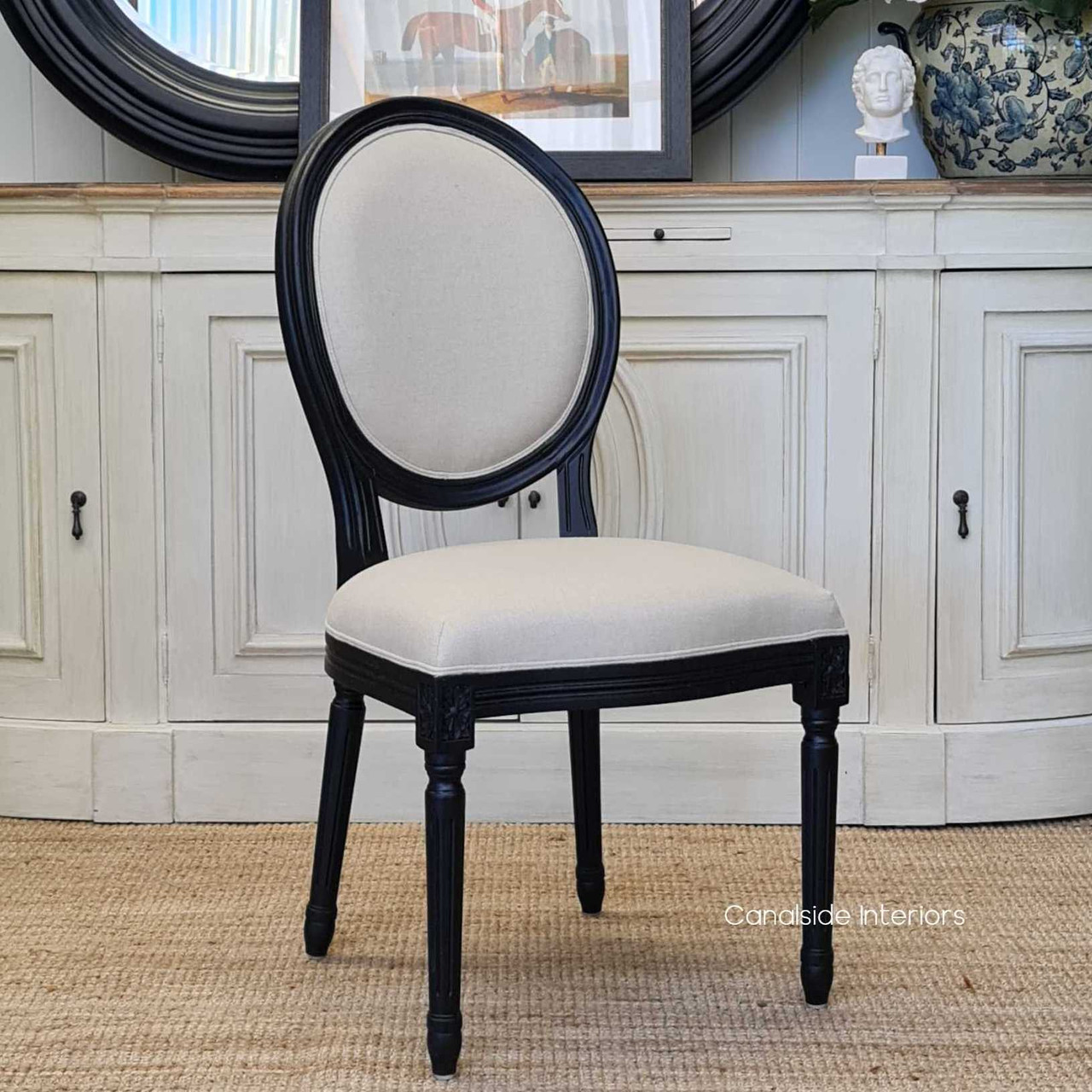 The French-inspired Sansa Dining Chair with distressed black and cream linen upholstery, a statement of elegance for a Hamptons-style dining area - Canalside Interiors