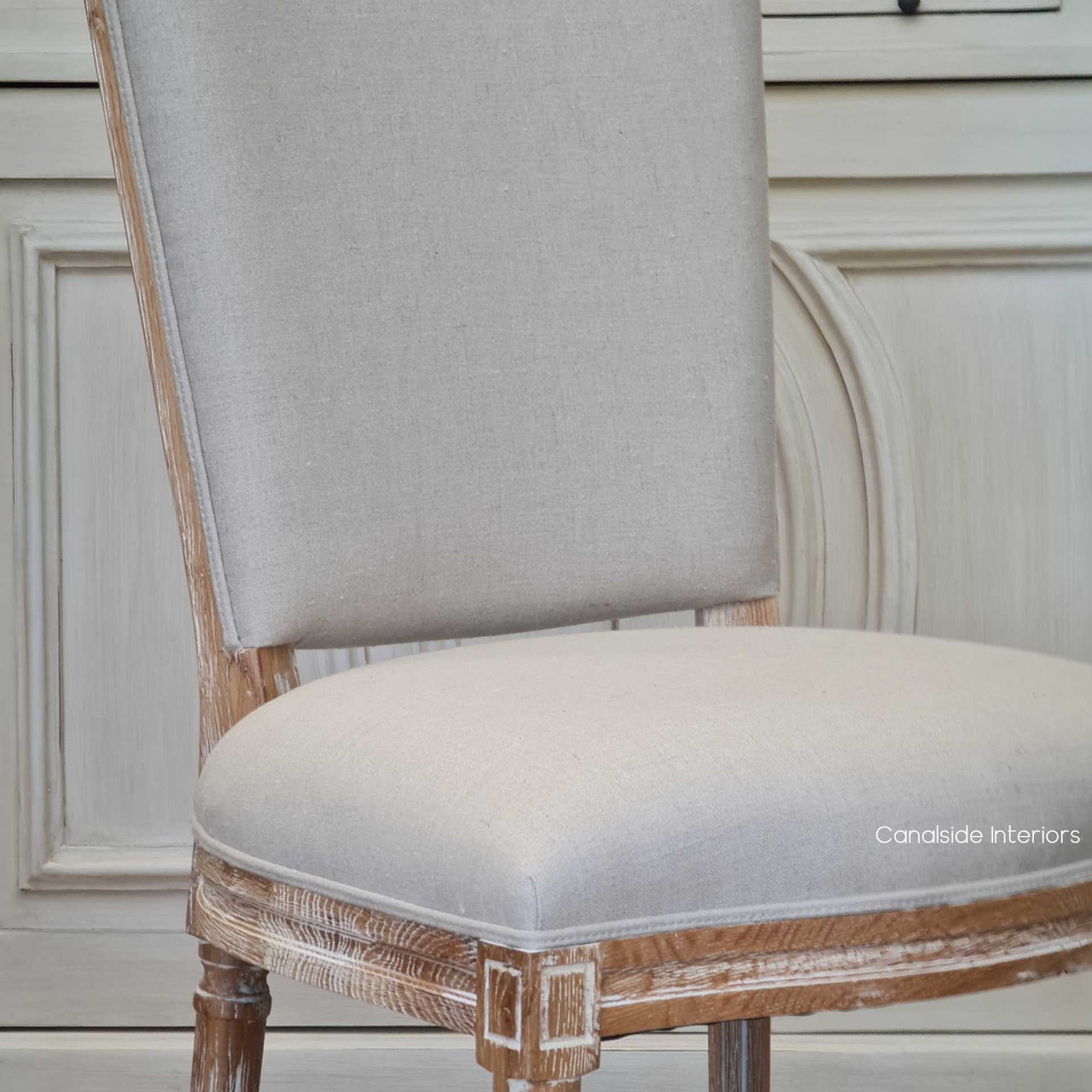 With its inviting cream upholstery, the Knightley Chair at Canalside Interiors brings a touch of coastal serenity to your dining space