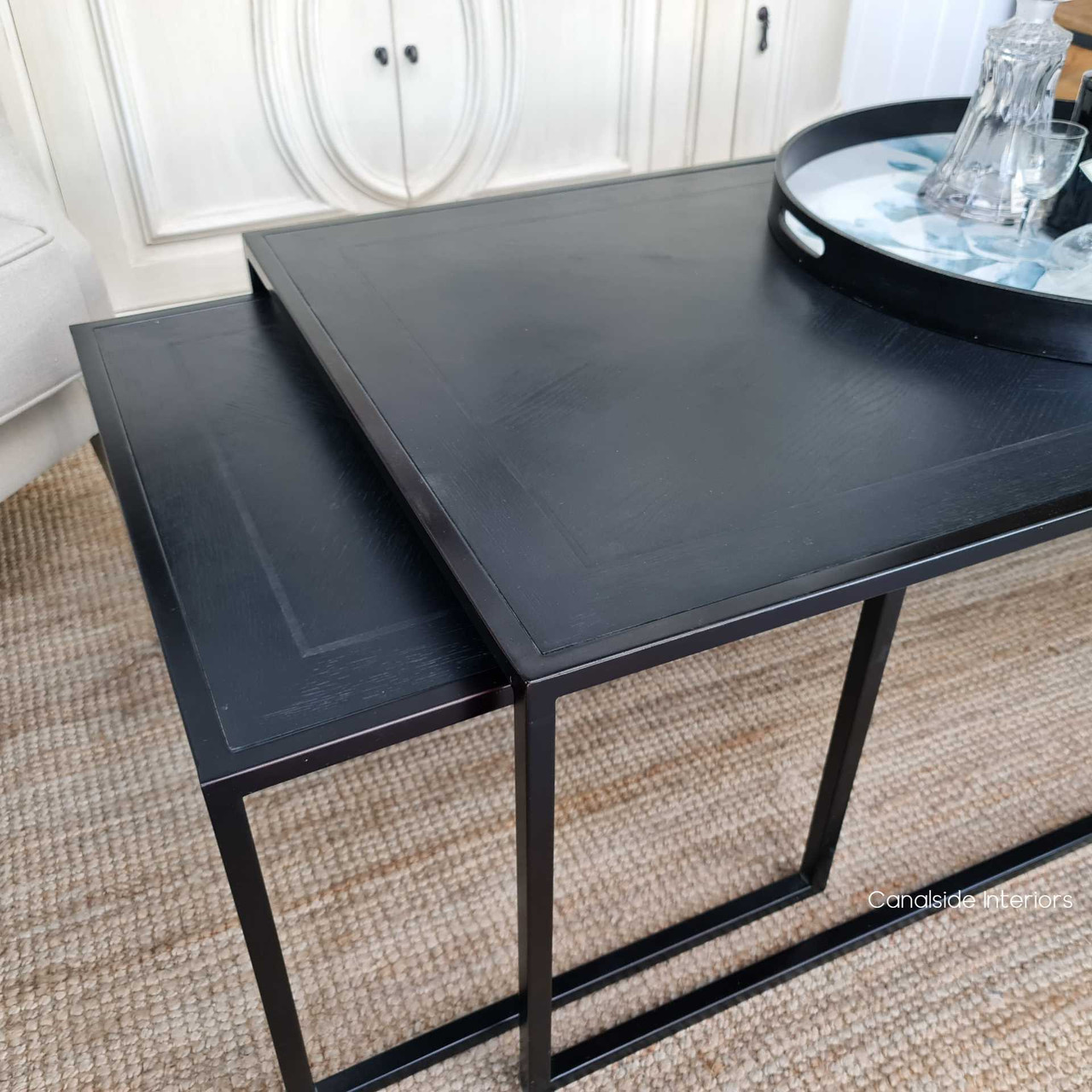 View of the tables partially nested, offering a versatile setup option for dynamic living room layouts.