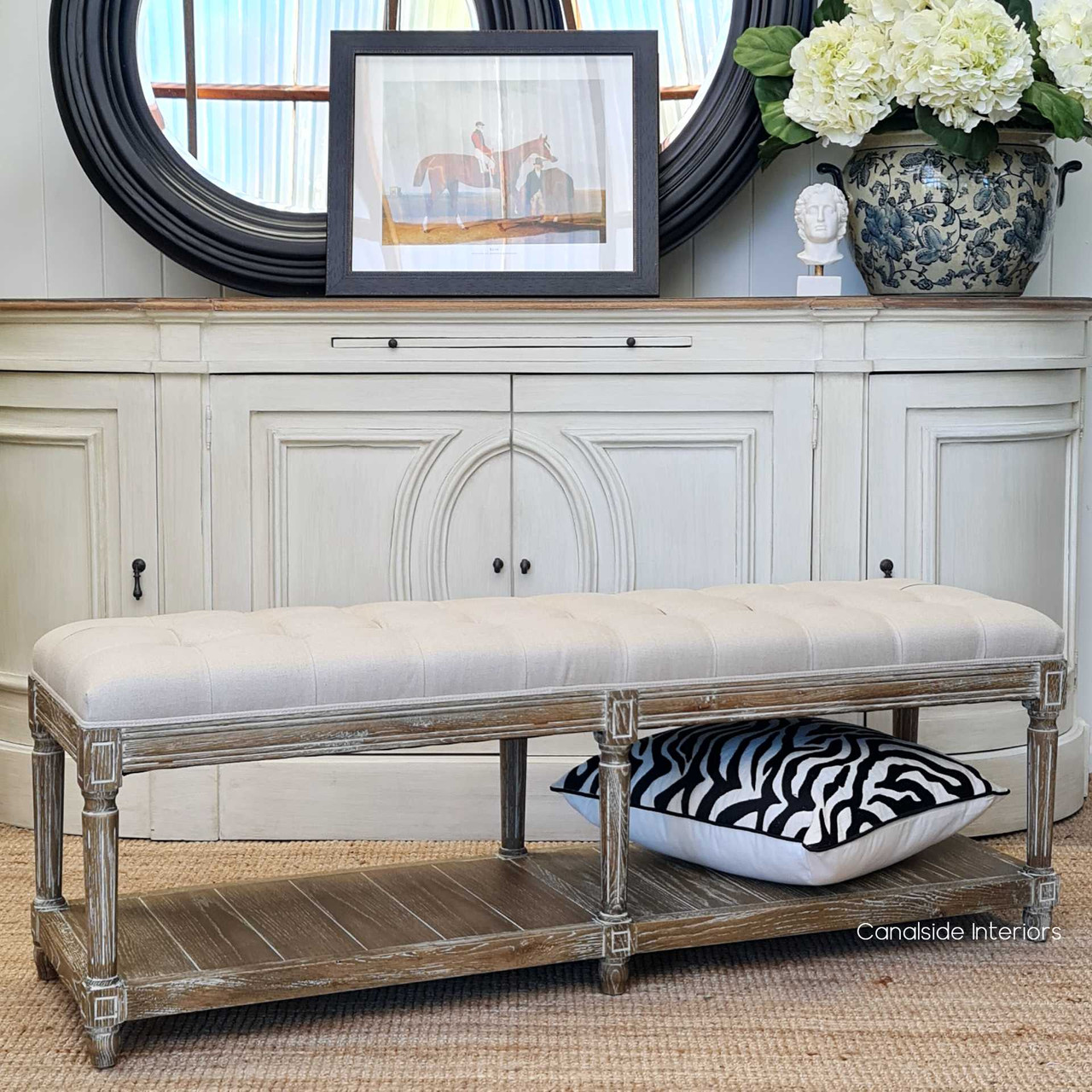 Lifestyle image of the ottoman in a cozy reading nook, providing both a chic seating option and additional storage space.