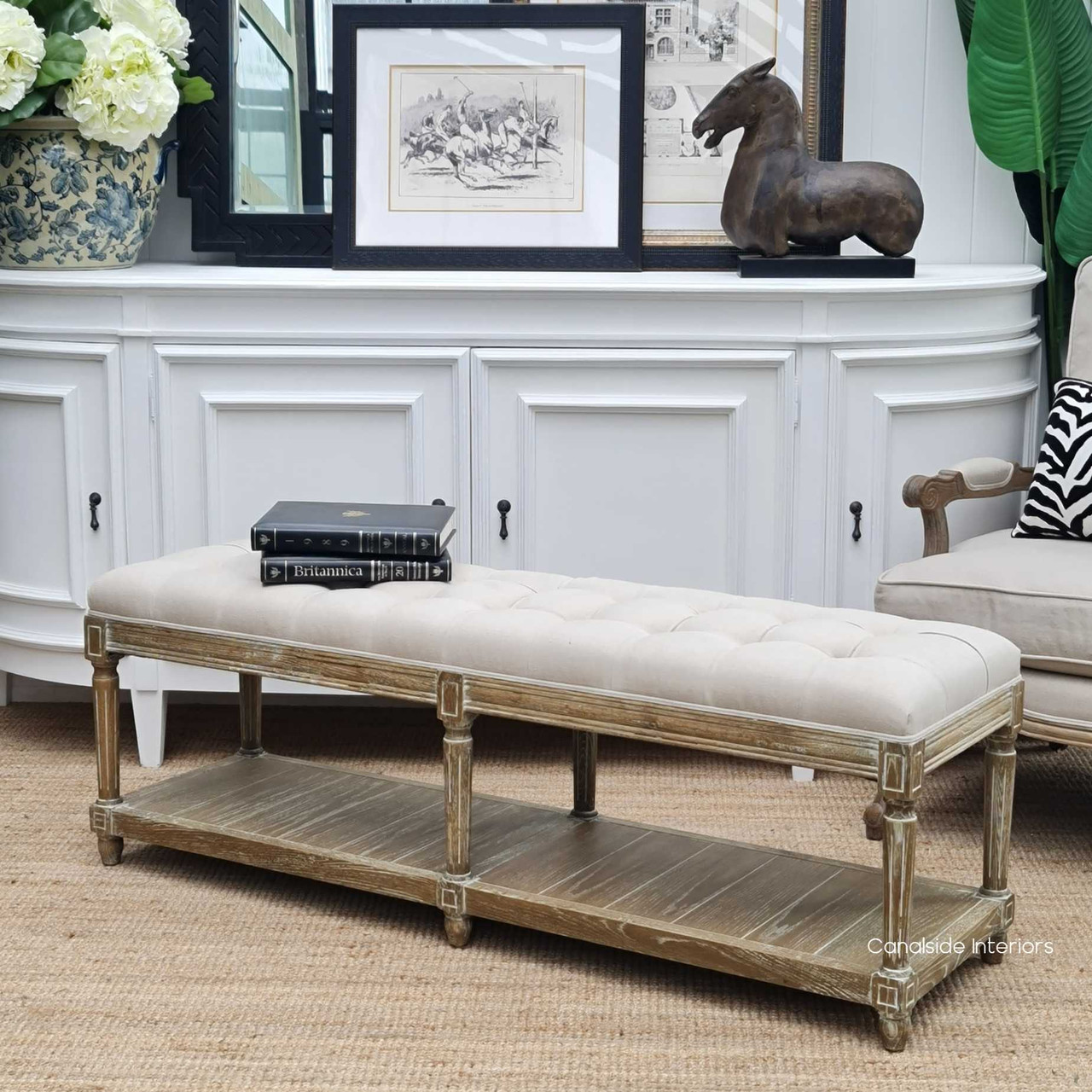 Elegant Providence Bed Ottoman in cream upholstery, set within a French Provincial-inspired bedroom, enhancing the space with its timeless design.