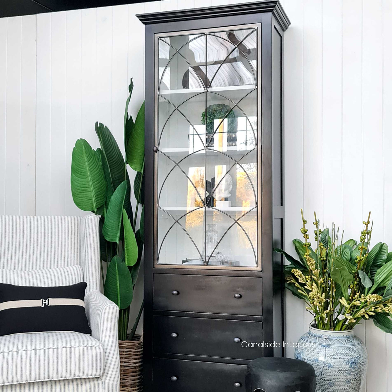 Angled view showcasing the contrast between the cabinet's dark exterior and bright white interior, emphasizing the piece's unique design.