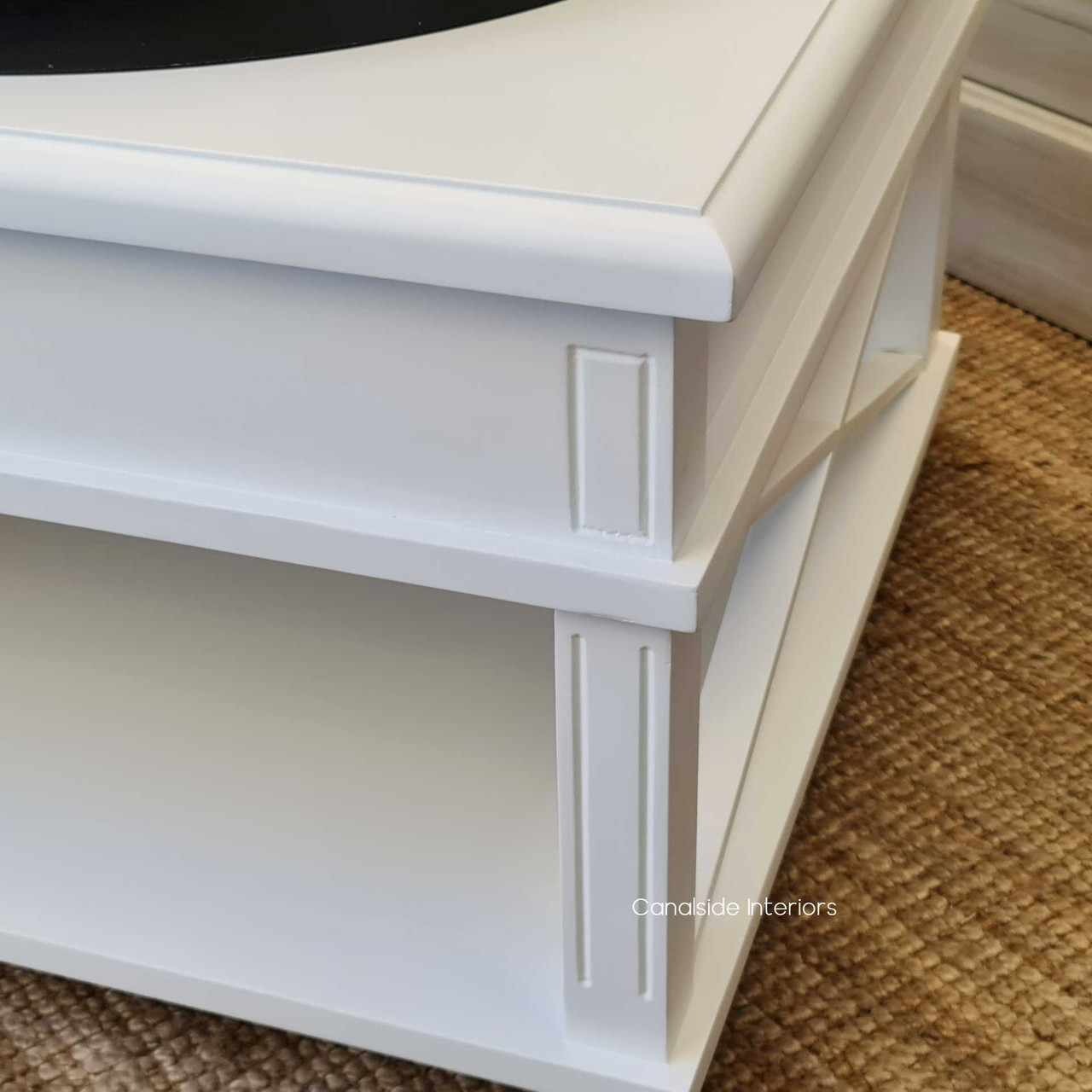 Accentuate your living room with the clean, linear profile of this white coffee table, a testament to Canalside Interiors' timeless design