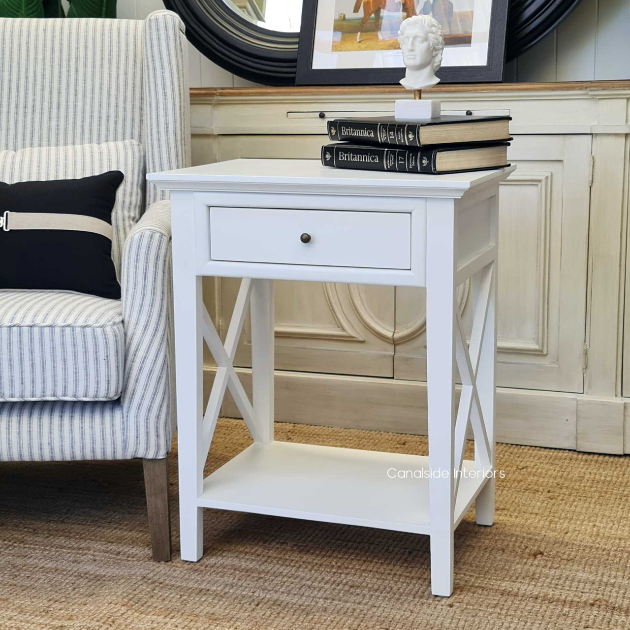 Achieve a chic library look with the Hampton Avenue Bedside Table, a refined piece with a timeless white finish - Canalside Interiors