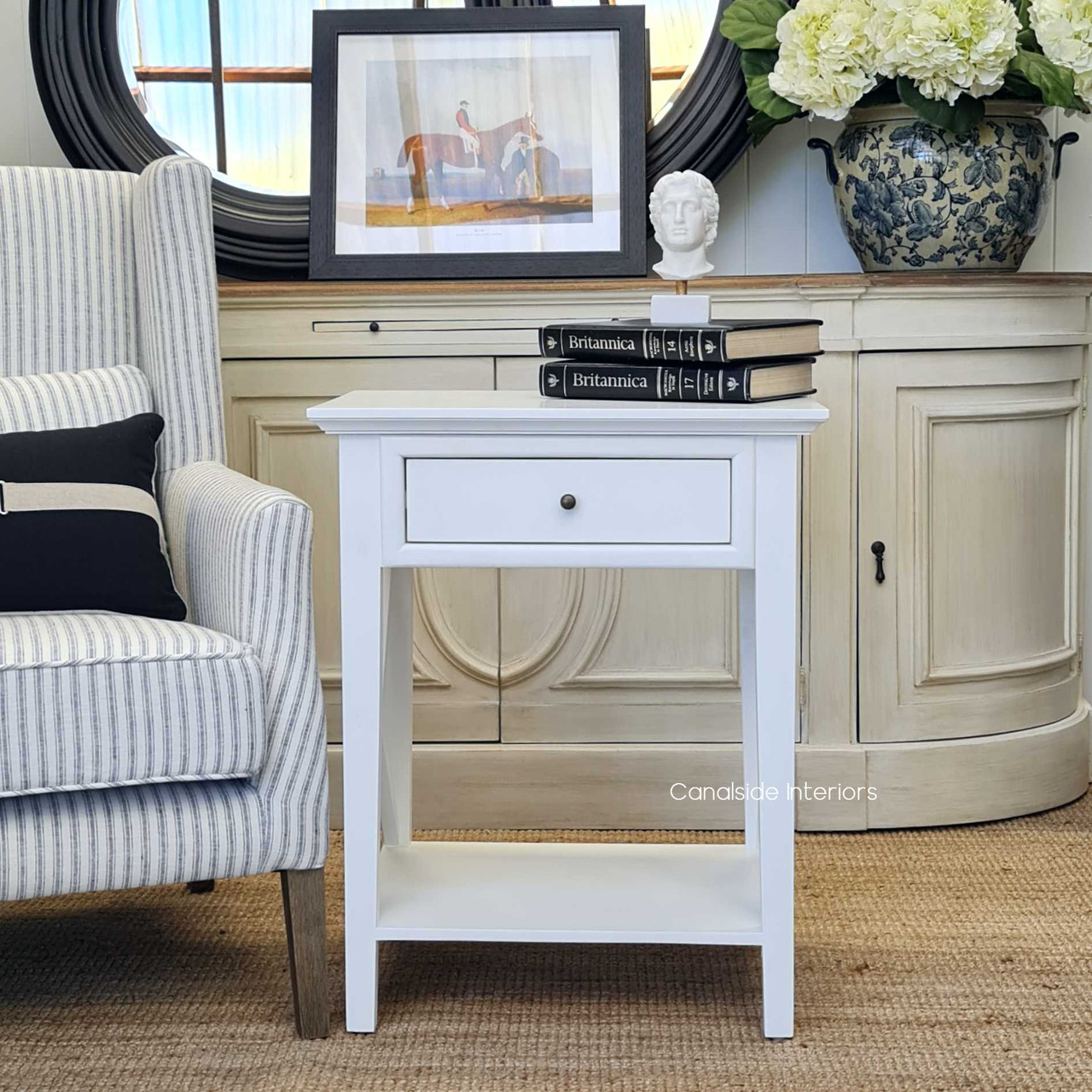 Timeless sophistication meets functional design with this white bedside table, perfect for coastal-inspired living rooms