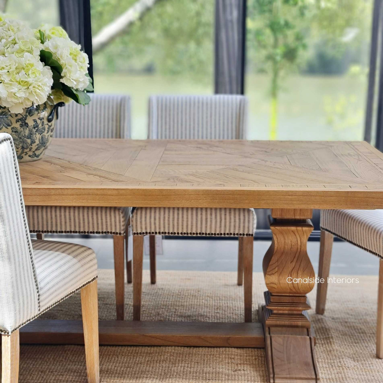 The artisanal beauty of the Danbury Oak Dining Table's parquetry pattern creates a focal point of luxury and timeless design in any dining space