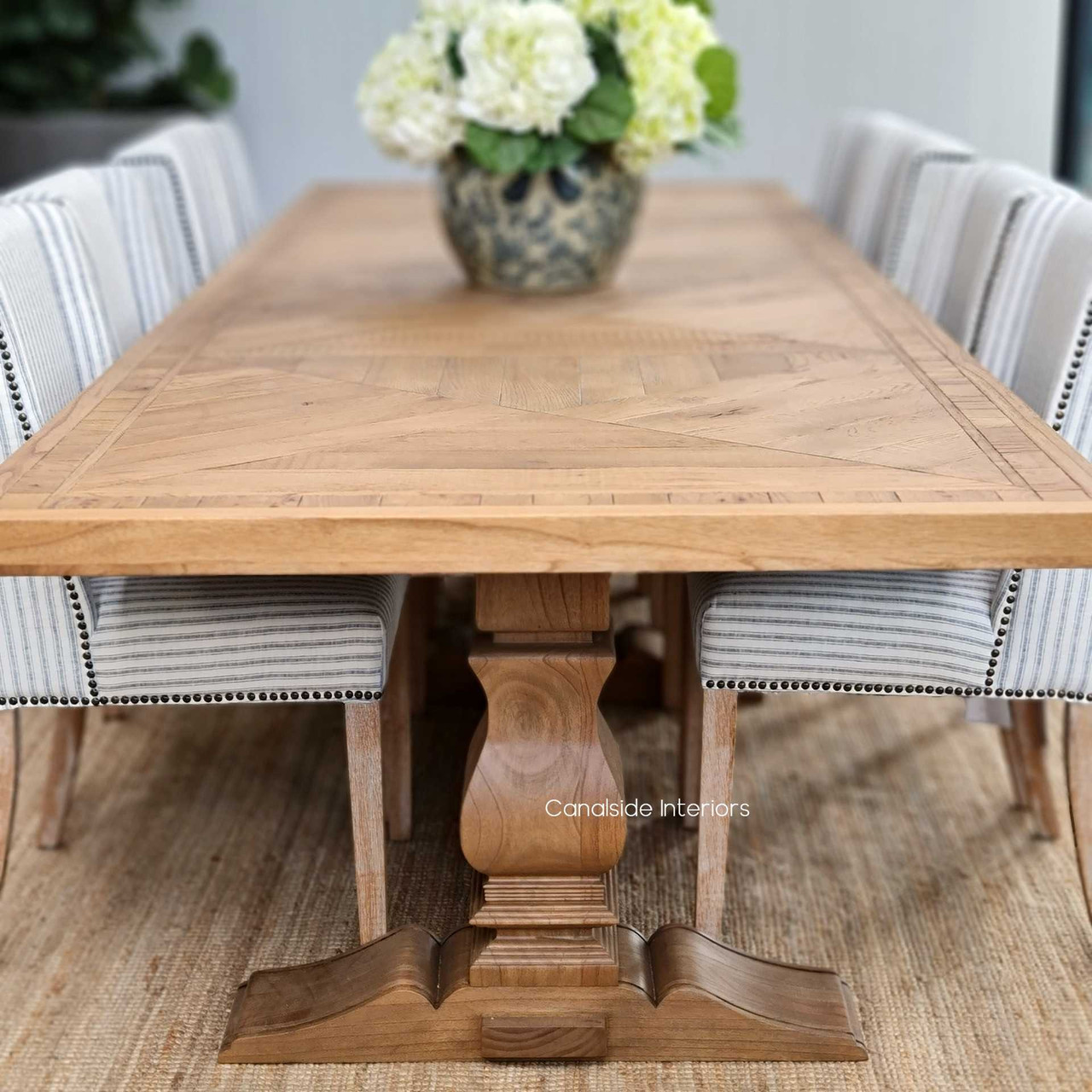 Anchor your dining room with the stately Danbury Oak Parquetry Dining Table, blending a sturdy pedestal base with a detailed oak surface for a timeless appeal