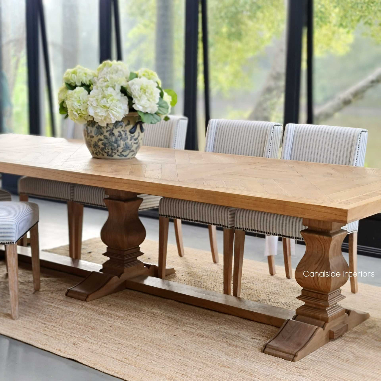 Indulge in the rustic elegance of the Danbury Oak Dining Table, where the art of parquetry creates a conversation piece for guests and family alike