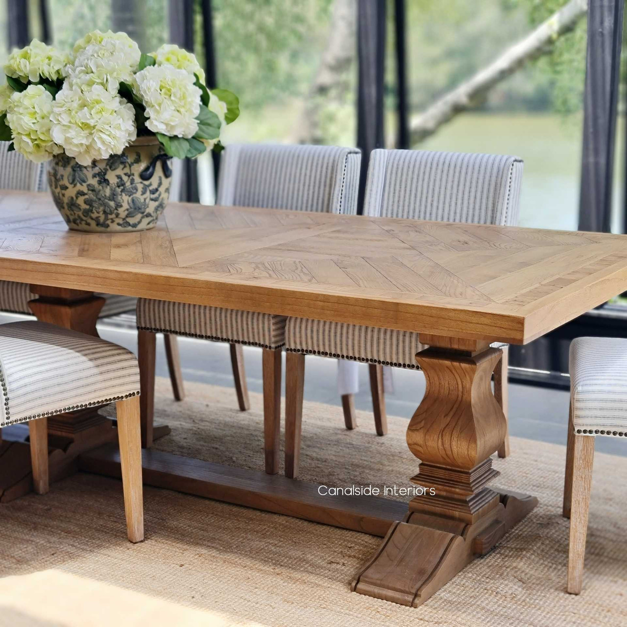 Elevate your dining experience with the exquisite Danbury Oak Parquetry Dining Table, featuring detailed craftsmanship for a refined aesthetic - Canalside Interiors.