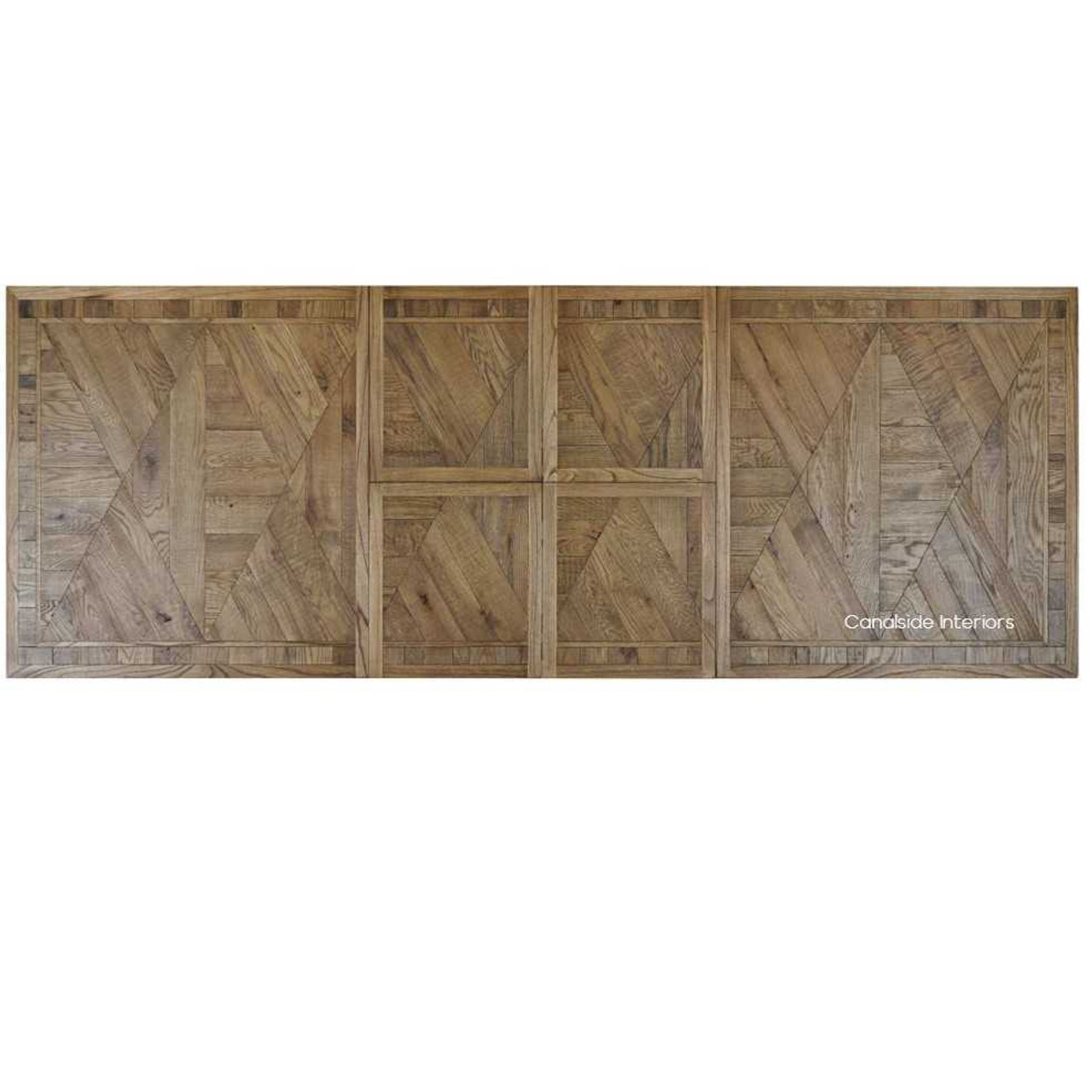 This handcrafted oak extendable table from the Danbury Range, with its smooth transitions, is the ultimate companion for a modern, versatile library or study room - Canalside Interiors.