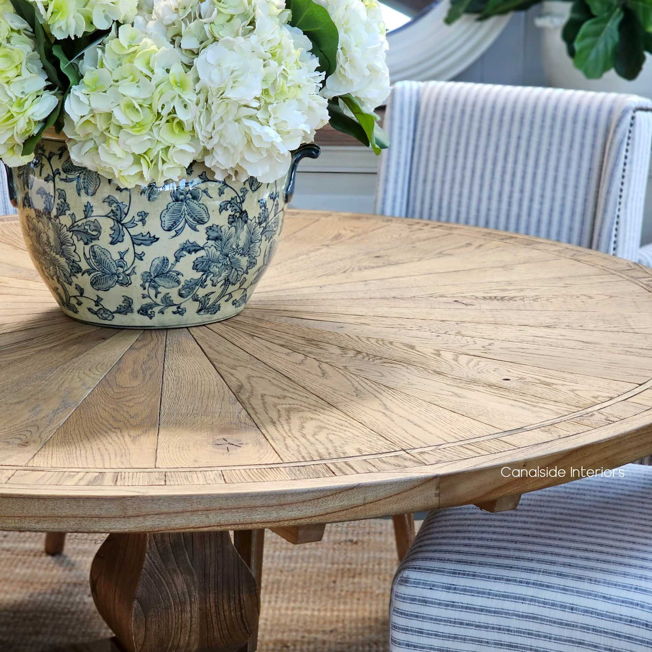 Rich in texture, the Danbury Oak Round Table's parquetry top showcases a kaleidoscope of natural wood tones, ideal for bringing a rustic touch to modern dining rooms - Canalside Interiors Sydney