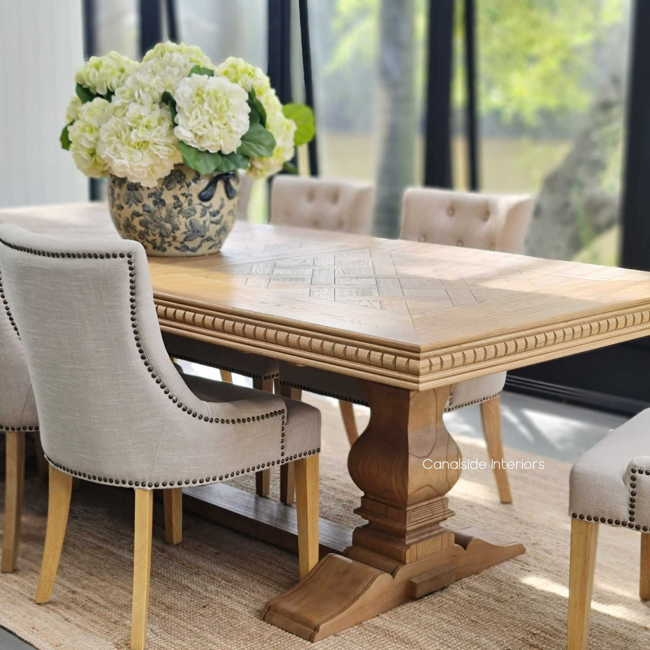 The Berenson Oak Dining Table featured in a luxurious coastal retreat, perfectly matching the serene and sophisticated decor.