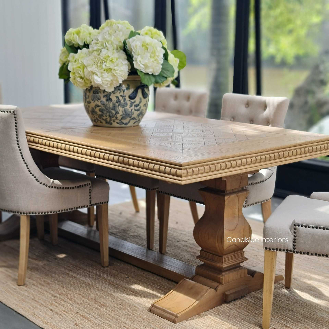 The table set in a chic Hamptons-style room, illustrating its stylish presence and functionality in coastal-inspired spaces.