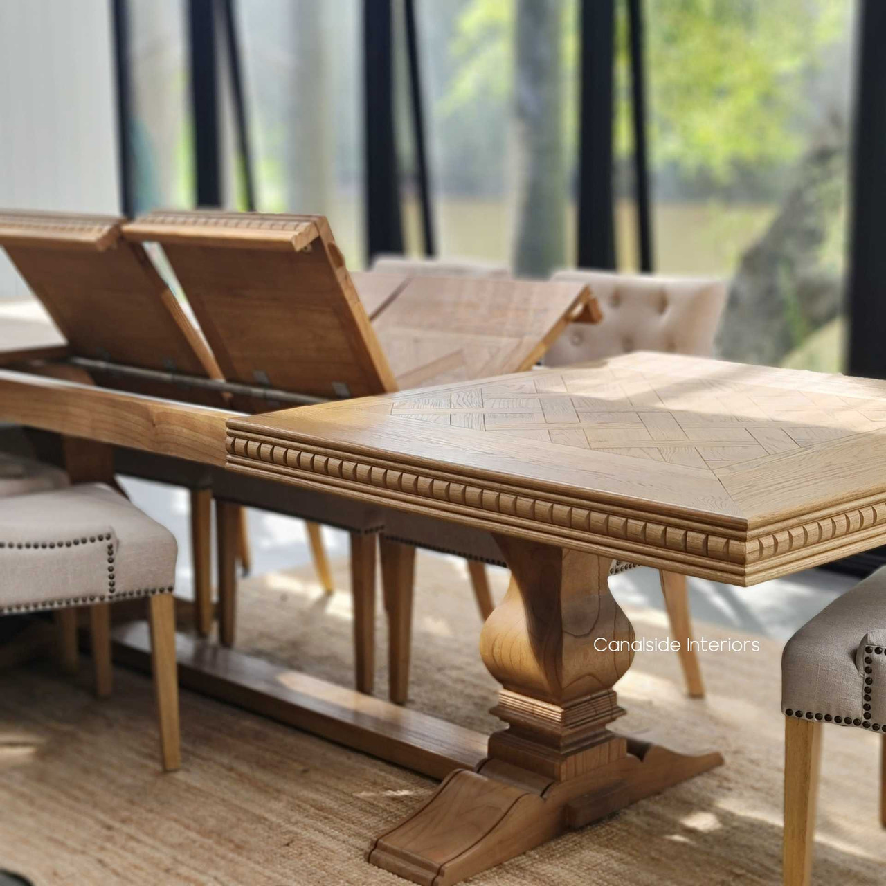 The extendable table set in a luxurious dining room, illustrating its perfect fit within both traditional and modern decor styles.