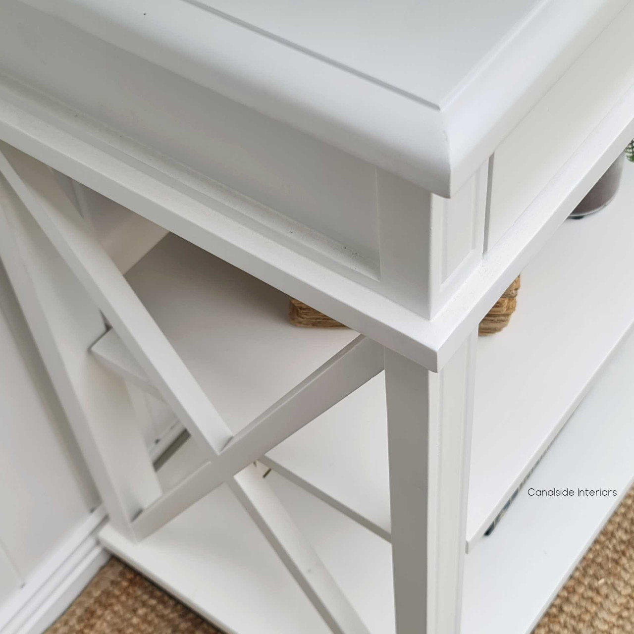 The minor distressing and functional storage of this console table accentuates the timeless quality of a contemporary library - Canalside Interiors