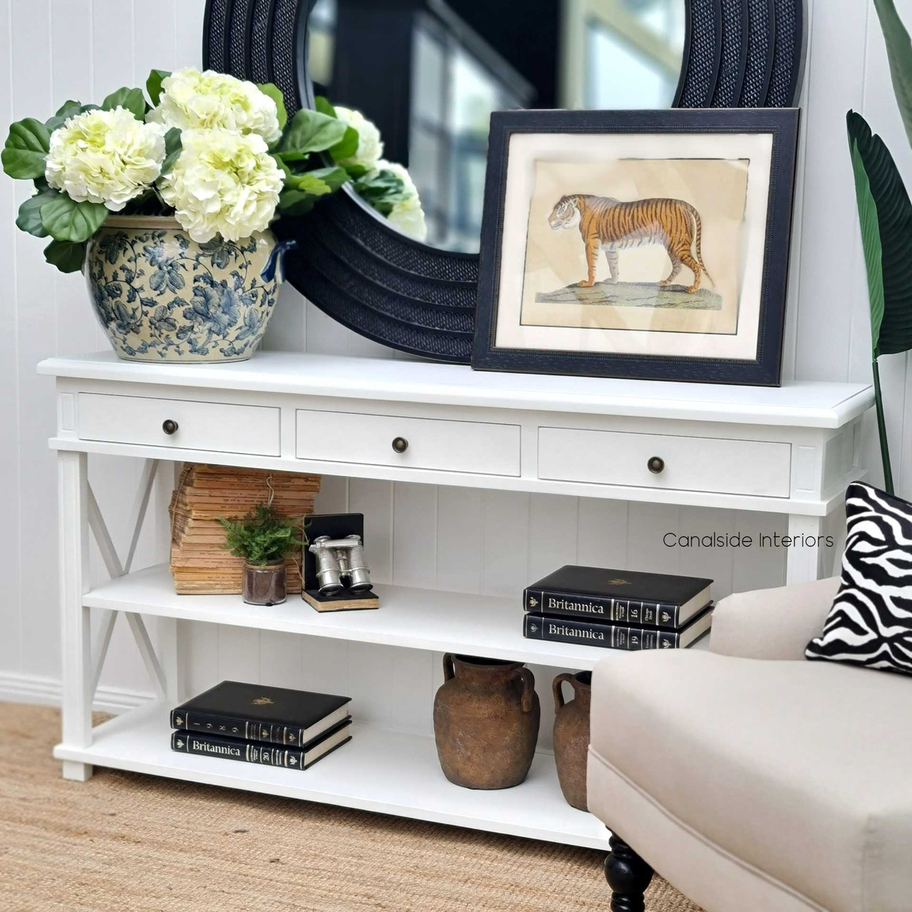 The white Hampton Avenue Console 3 Drawers & 2 Shelves with its classic 'Cross' motif enhances the layered look of a Hamptons-style living room - Canalside Interiors