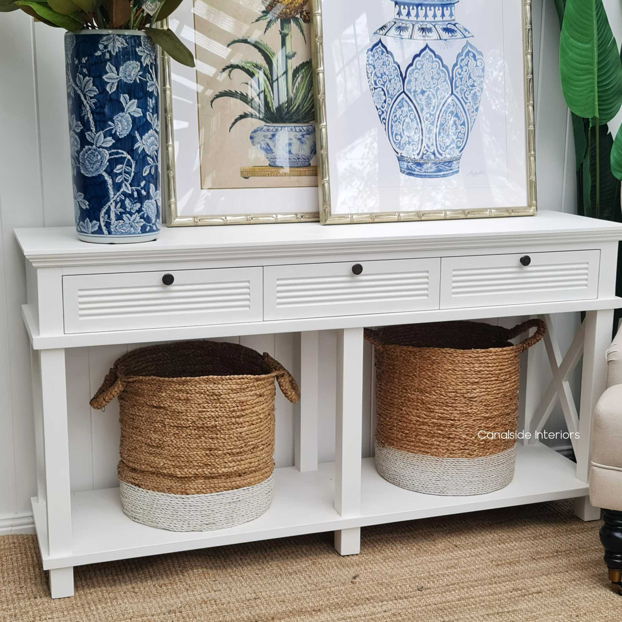 This coastal-inspired white console table is perfect for the foyer, offering a warm welcome in Hamptons style