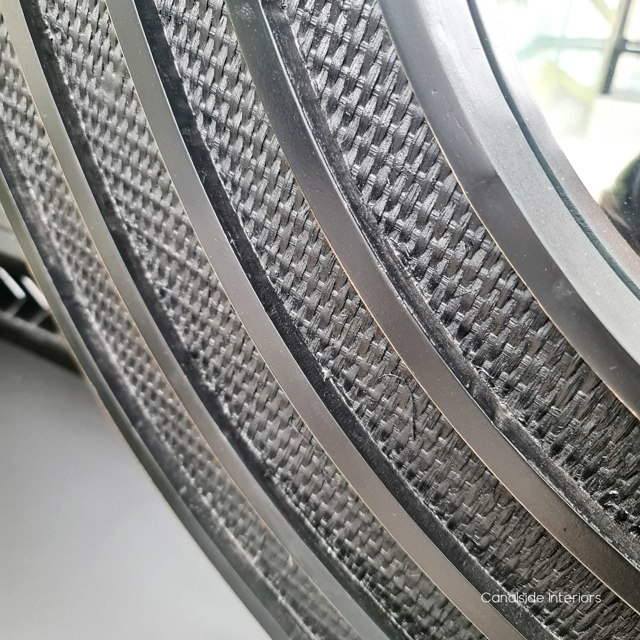 Close-up on the mirror's intricate rattan work, emphasizing the high-quality craftsmanship and the unique distressed black/charcoal finish.