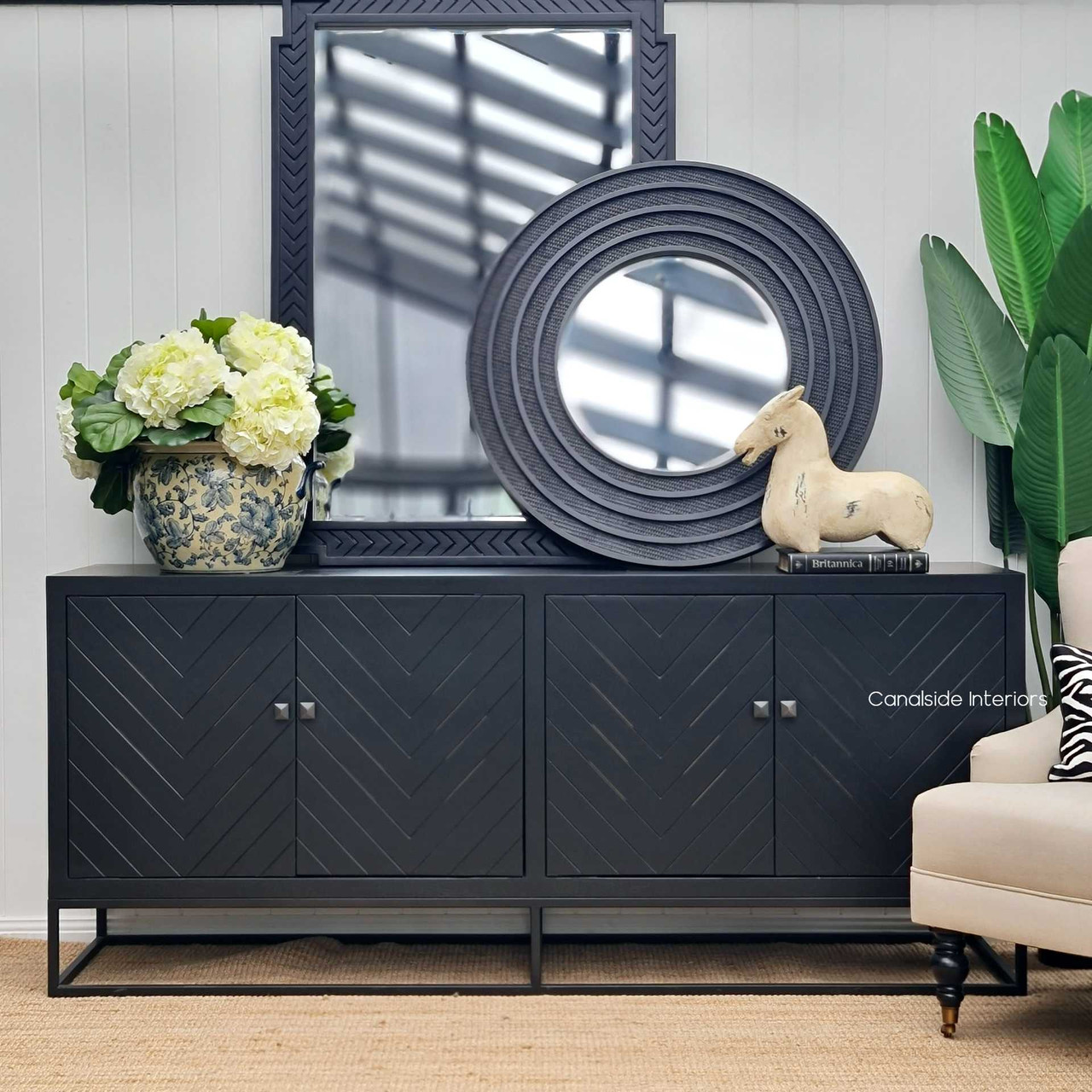 The Brielle Rattan Mirror set against a Hamptons-style interior backdrop, perfectly blending casual elegance with coastal charm.