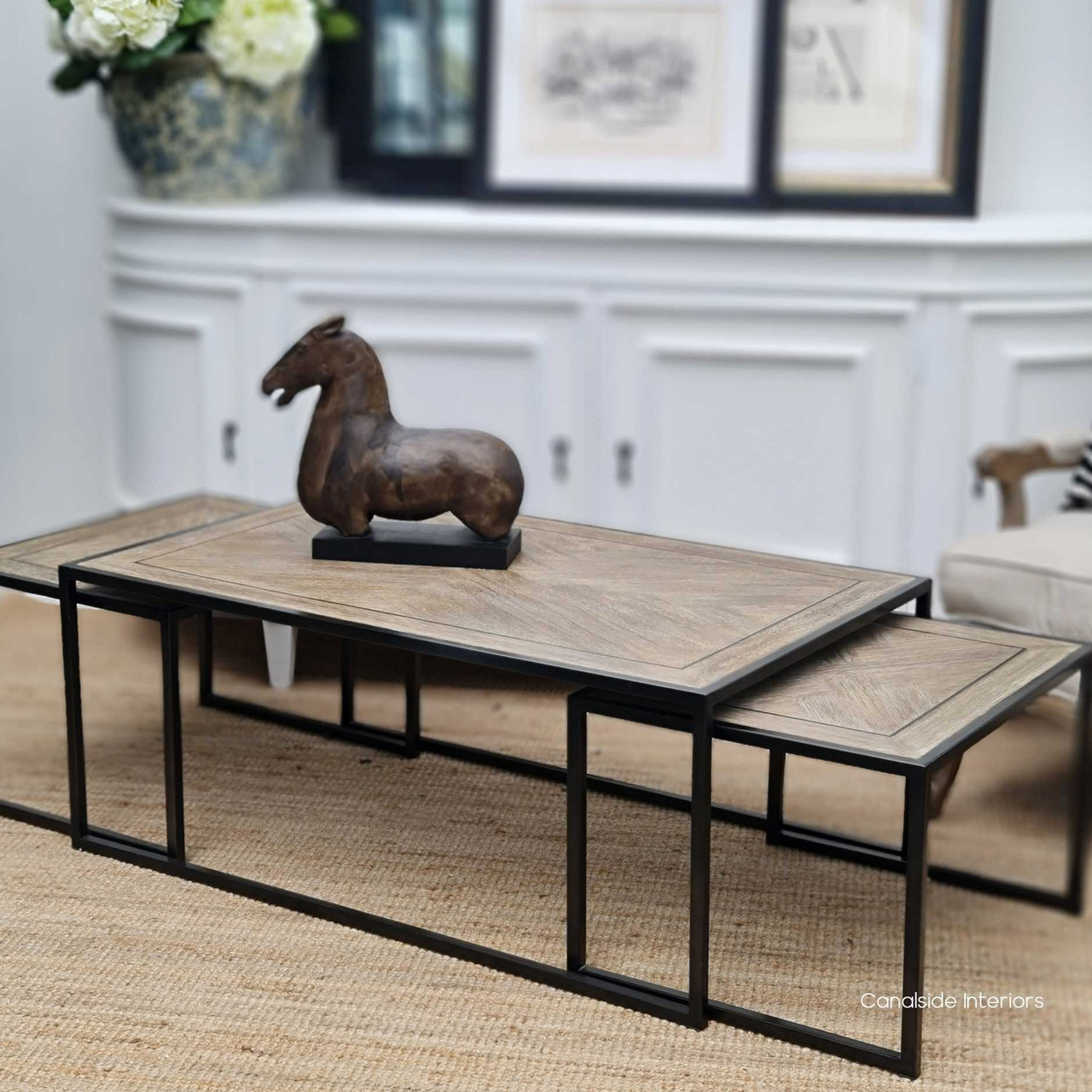 The nested configuration of the coffee tables, illustrating a compact and sleek footprint for smaller living spaces.