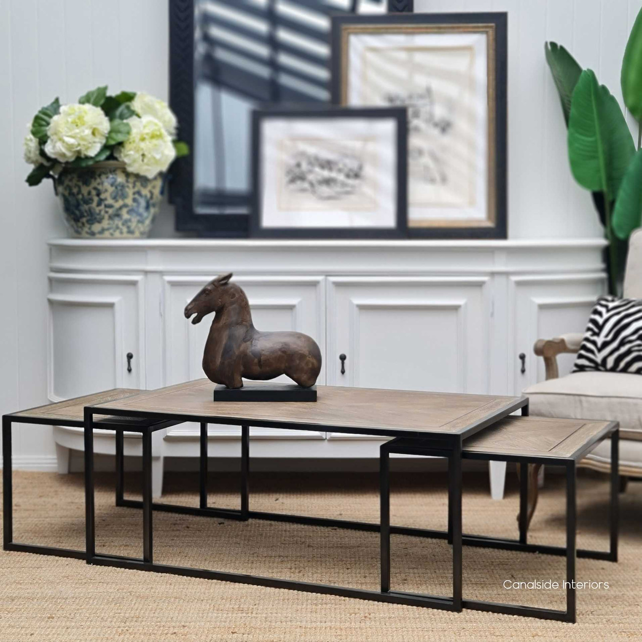 Close-up of the metal frame, highlighting the sturdy construction and sleek design that supports the oak tops.