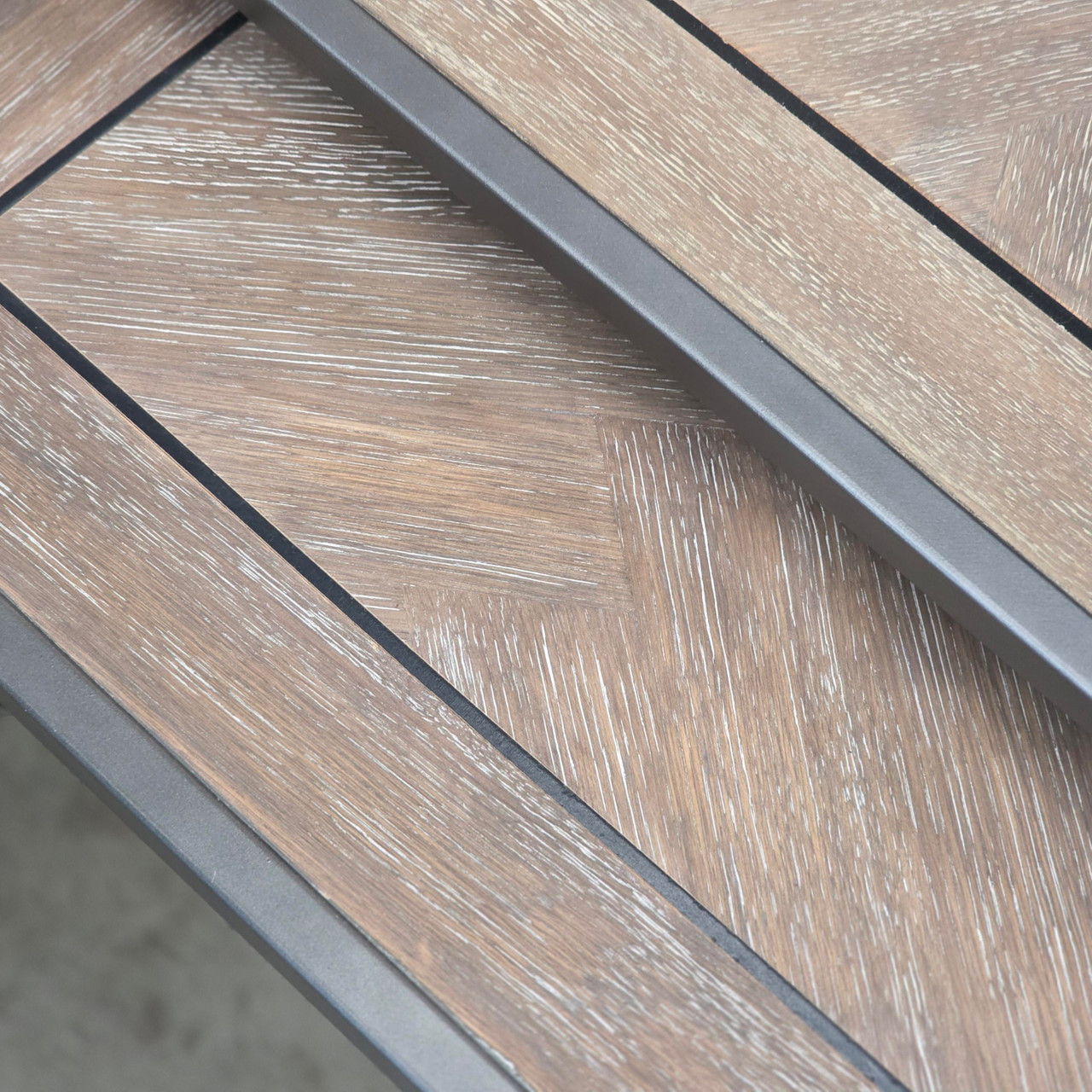 Close-up of the herringbone pattern on the weathered oak top, highlighting the intricate details and quality craftsmanship.
