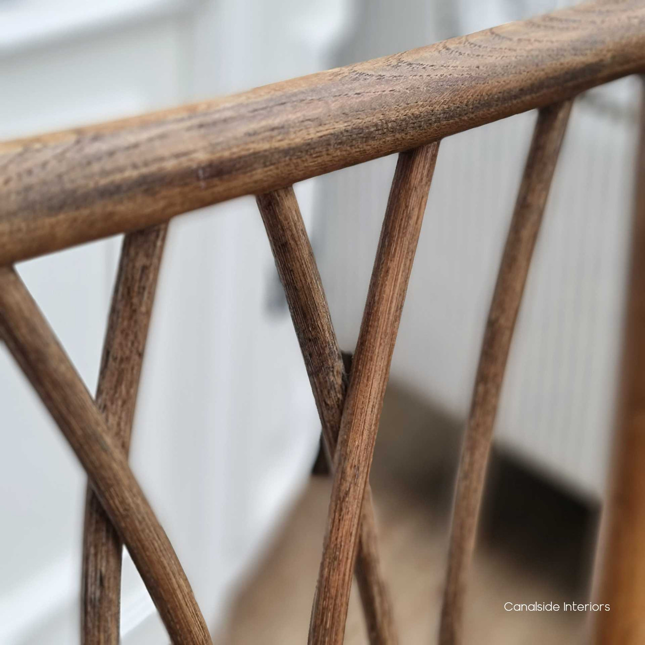 The Botanica Chair's intricate detailing, with its distressed burnished oak construction, complements the relaxed sophistication of coastal interiors