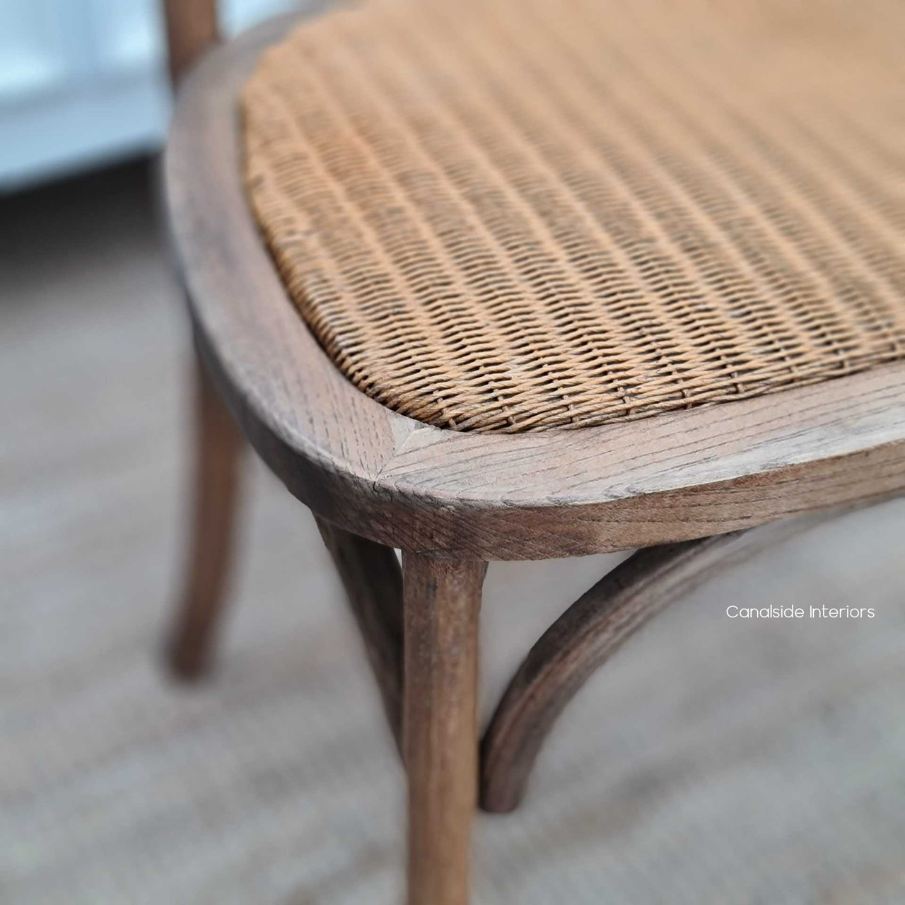 Close-up of the Botanica Dining Chair's oak frame and rattan seat, illustrating the Colonial and Plantation style details - Canalside Interiors