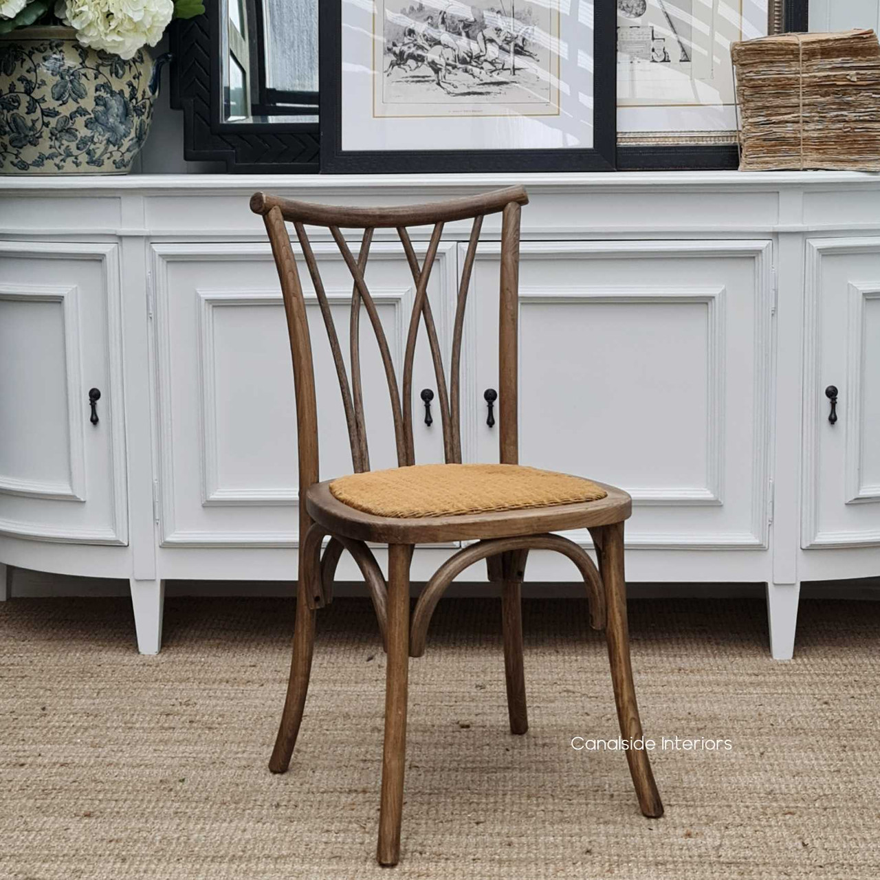Side view of the Botanica Chair's diamond back design and sabre-style legs, adding a sophisticated touch to any dining room setting