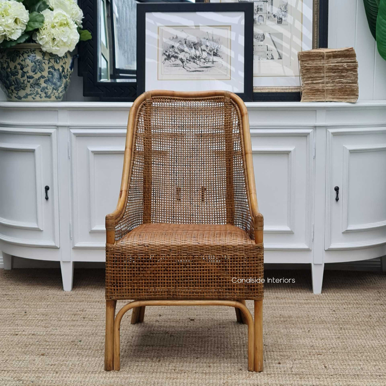 Elegant profile shot of the St Croix Rattan Chair, capturing the Manuka finish and highlighting its suitability for stylish dining rooms.