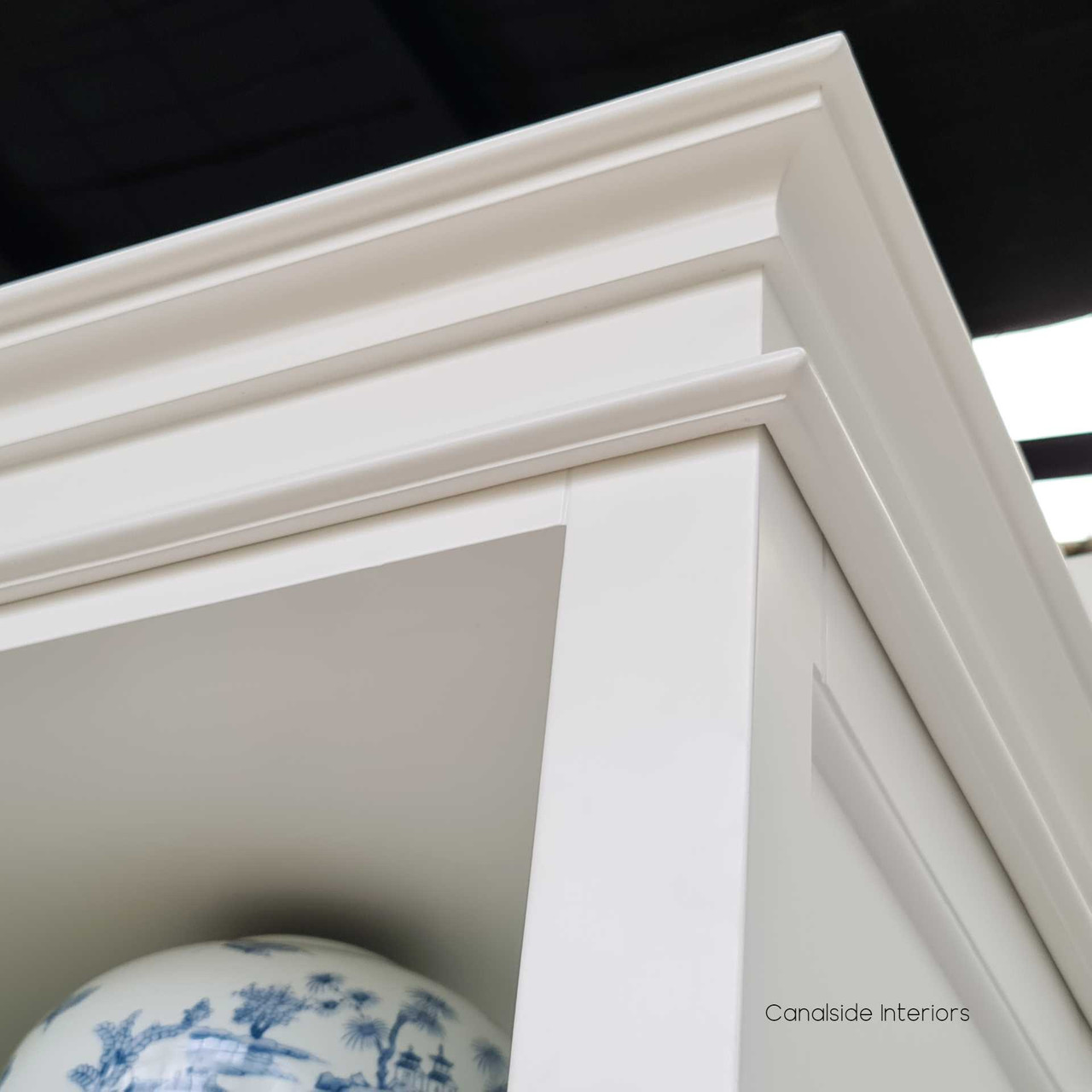 Angled view focusing on the Grange Wall Unit's top crown molding, a testament to Canalside Interiors' attention to detail in quality furniture