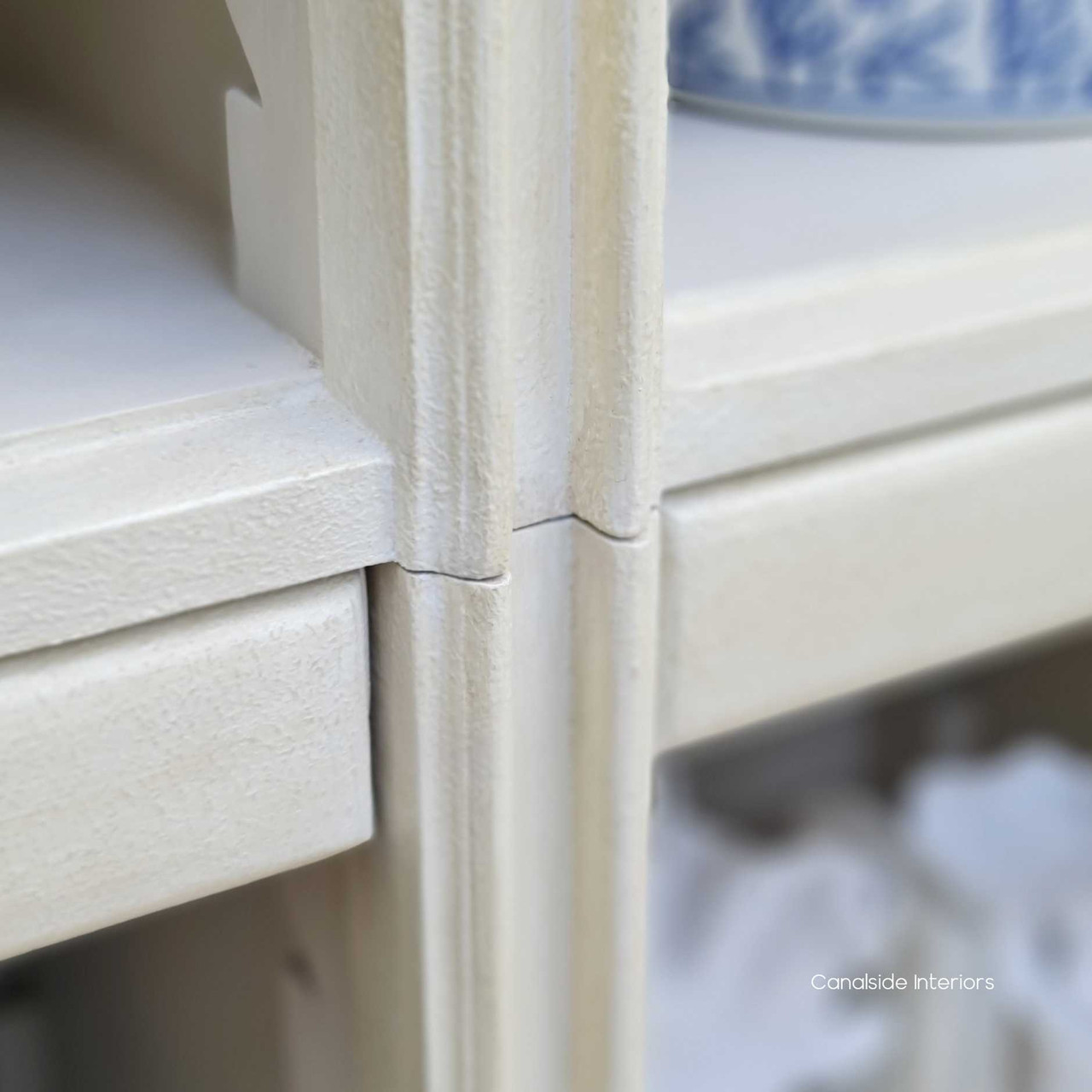 Angle showcasing the hand-finished patina of the Biblioteque Bookshelf, creating a focal point in a Hamptons-inspired study