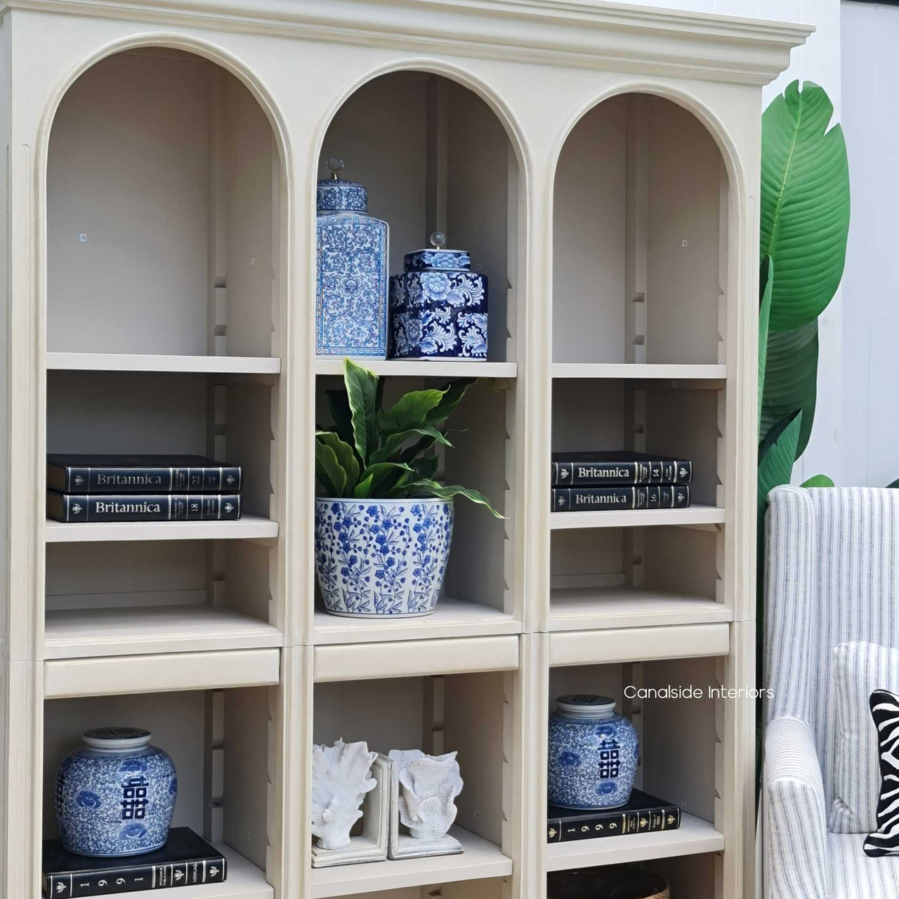 The Biblioteque Bookshelf's arch and shelves captured in natural light, enhancing the sesame finish in a quality lounge room