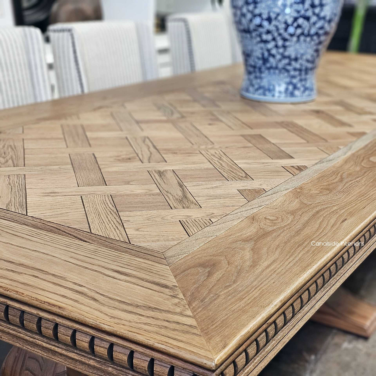 Close-up on the hand-laid parquetry top with exquisite border inlays, reflecting the table's uncompromised quality and detail.