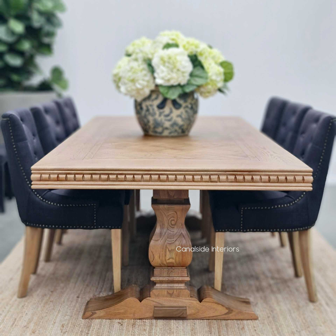 The table set against a minimalist backdrop, demonstrating its versatility and appeal in various home decors.